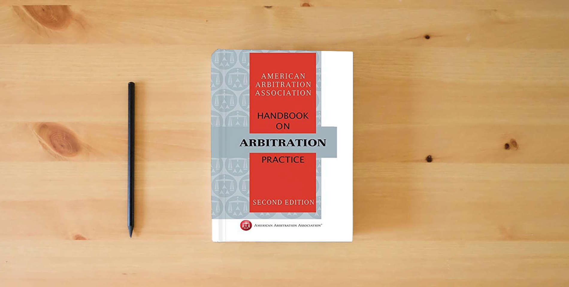 The book AAA Handbook on Arbitration Practice - Second Edition is on the table