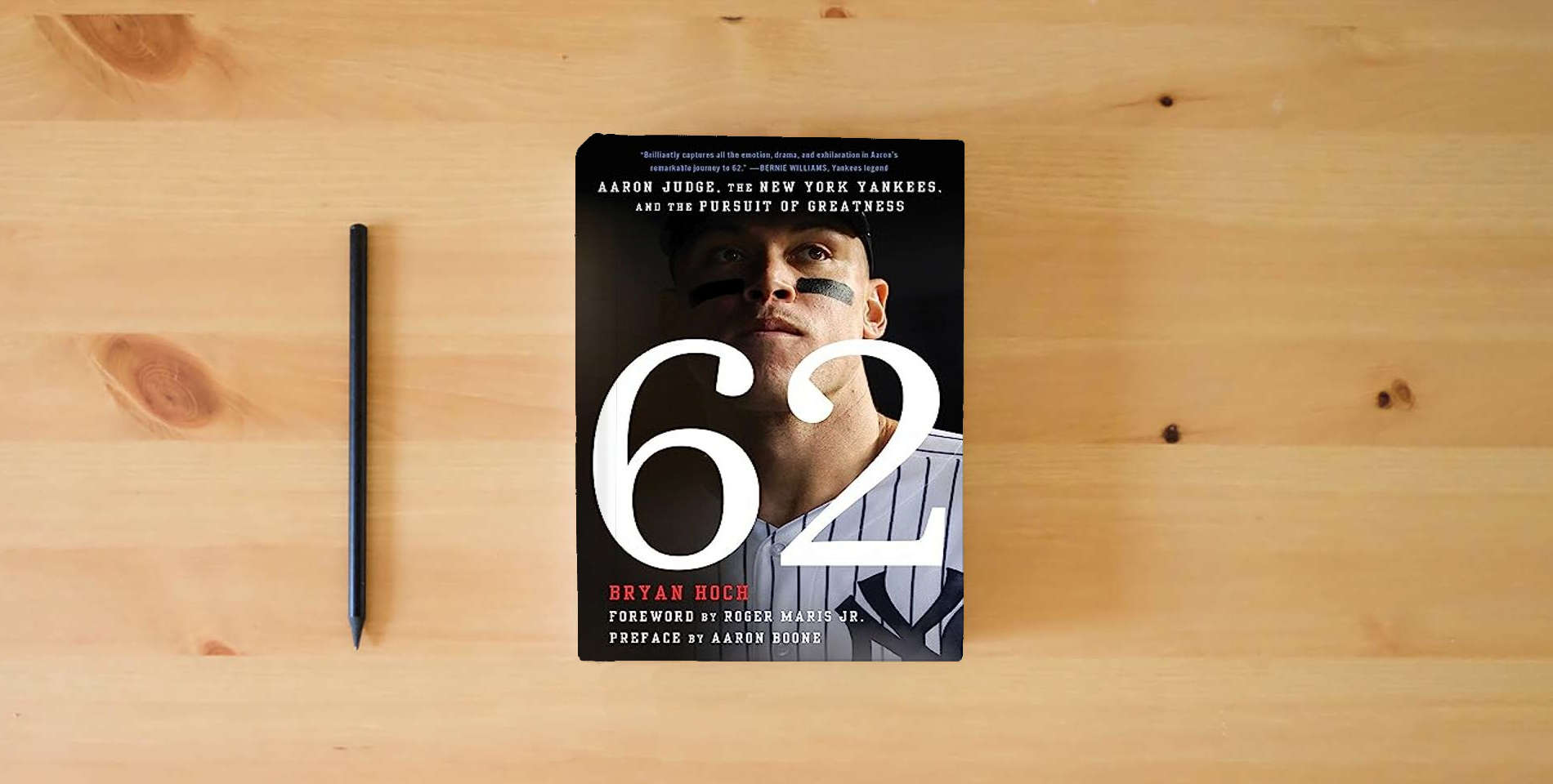 The book 62: Aaron Judge, the New York Yankees, and the Pursuit of Greatness is on the table