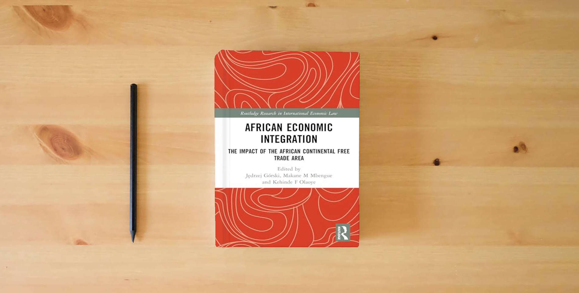The book African Economic Integration: The Impact of the African Continental Free Trade Area (Routledge Research in International Economic Law) is on the table