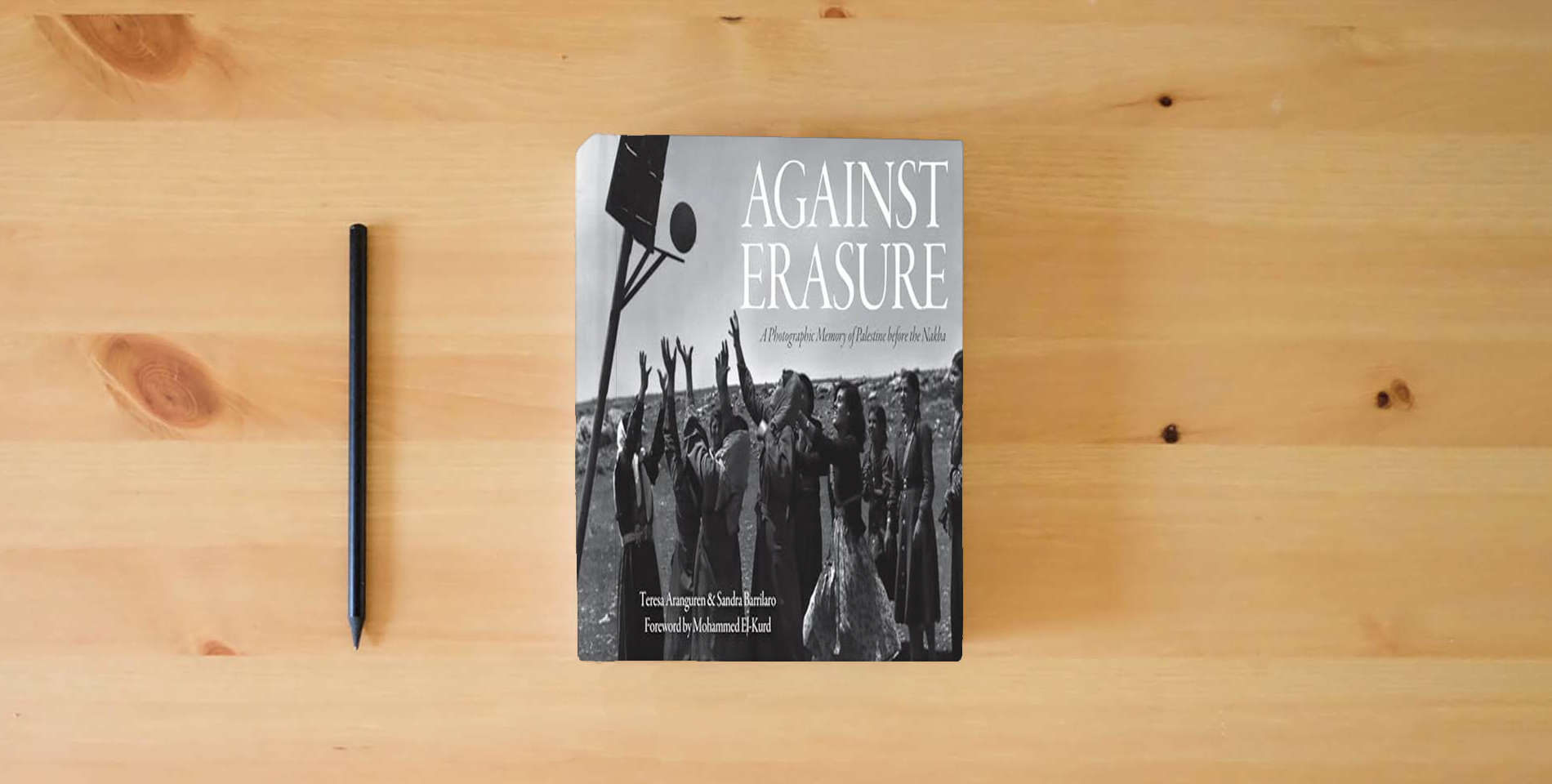 The book Against Erasure: A Photographic Memory of Palestine Before the Nakba is on the table
