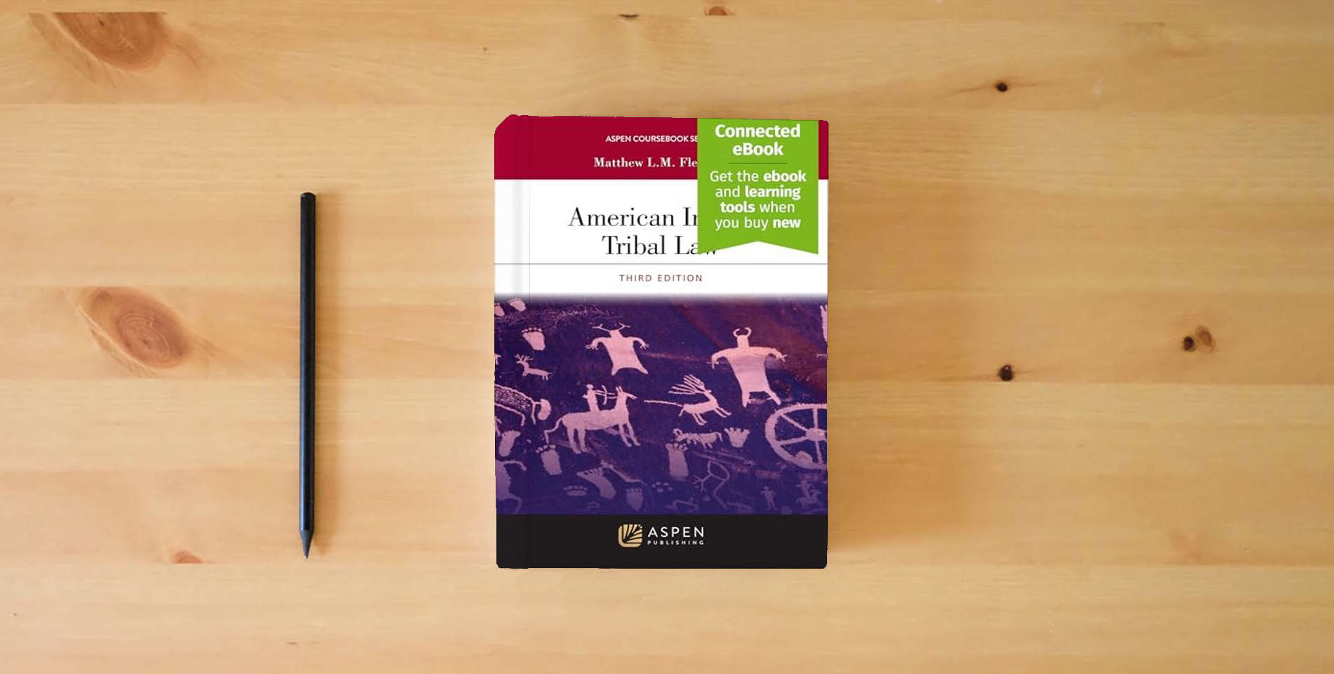 The book American Indian Tribal Law: [Connected eBook] (Aspen Coursebook Series) is on the table
