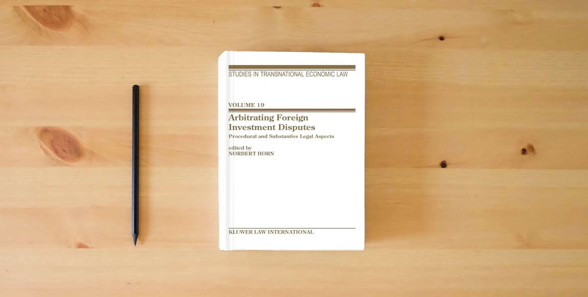 The book Arbitrating Foreign Investment Disputes: Procedural And Substantive Legal Aspects (Studies in Transnational Economic Law Set) is on the table