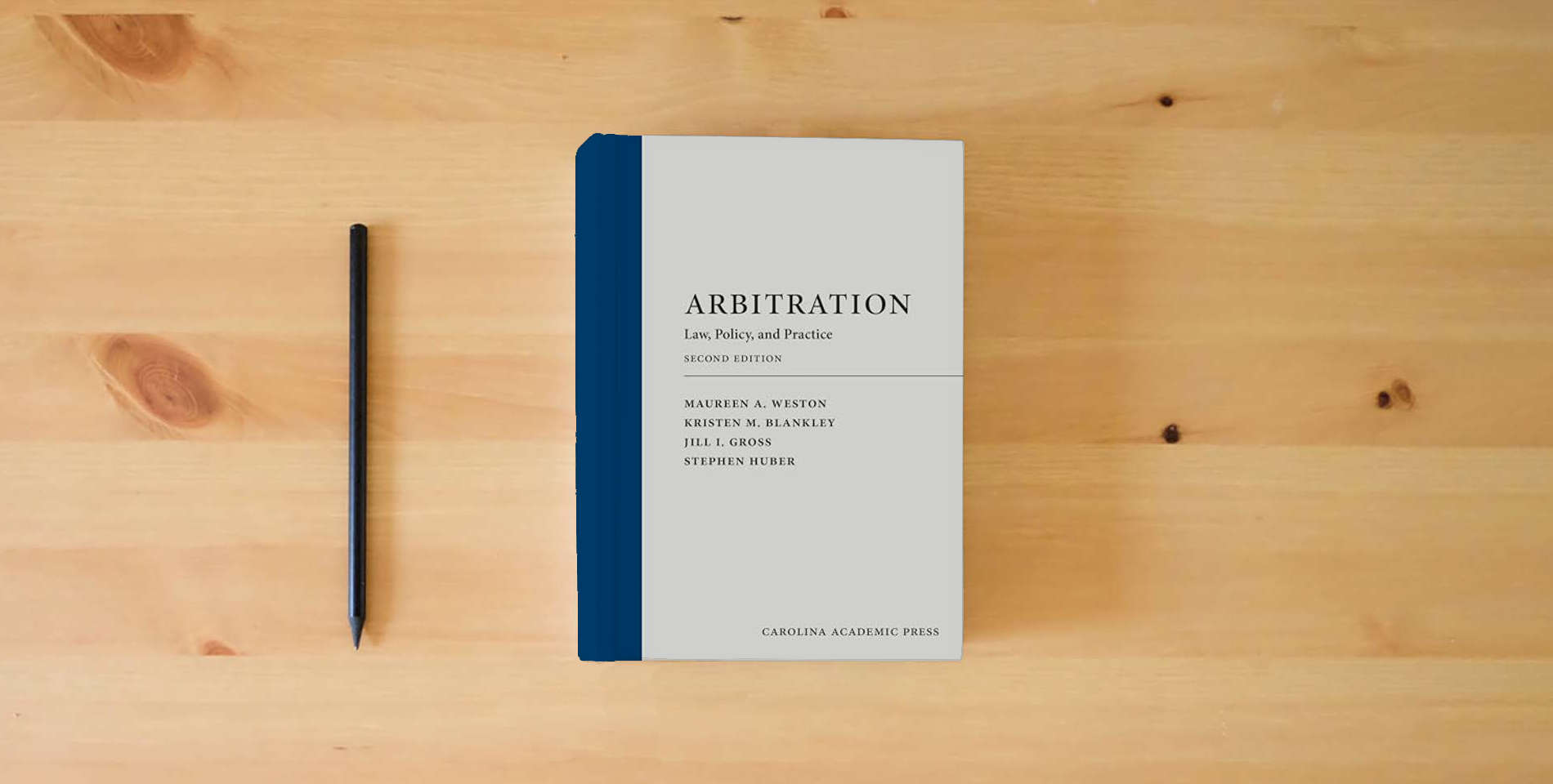 The book Arbitration: Law, Policy, and Practice is on the table