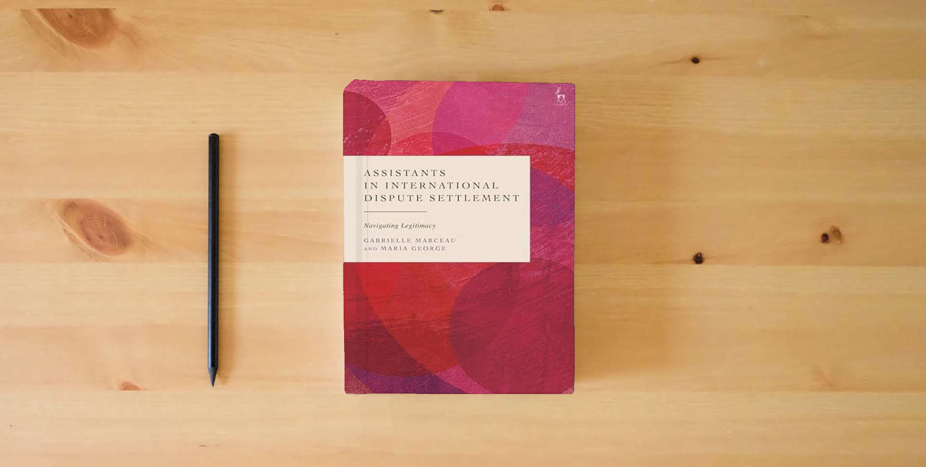 The book Assistants in International Dispute Settlement: Navigating Legitimacy is on the table