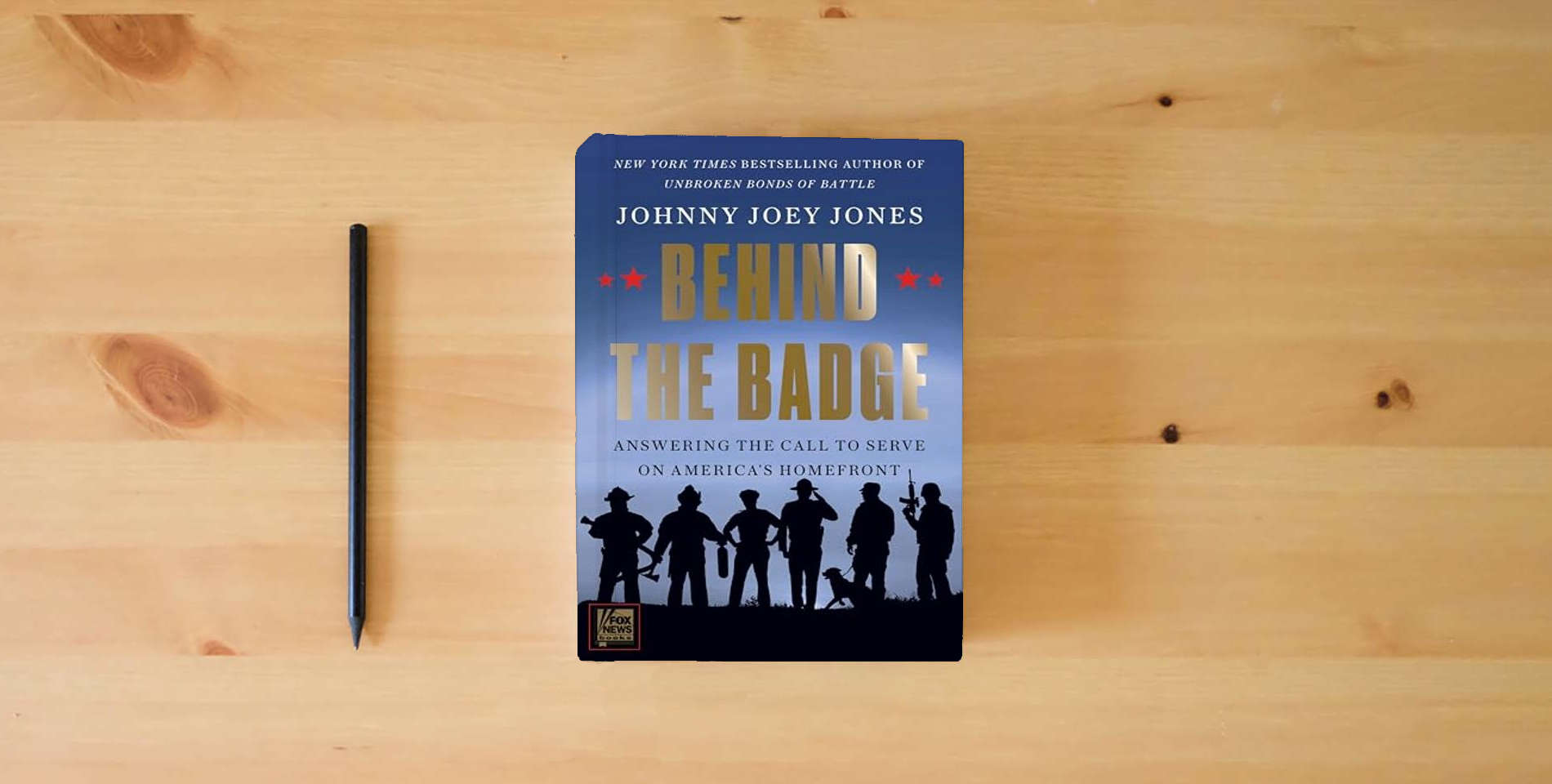The book Behind the Badge: A Heartfelt Look at the Lives of First Responders in America is on the table