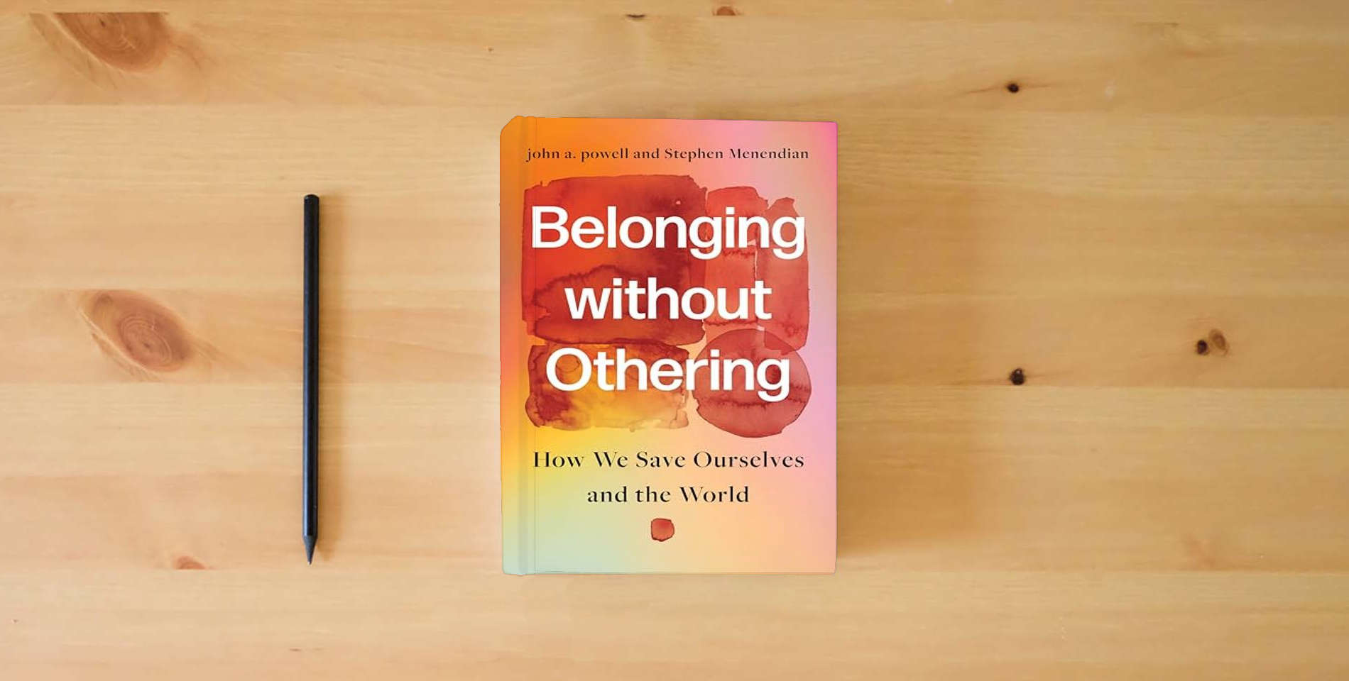 The book Belonging without Othering: How We Save Ourselves and the World is on the table