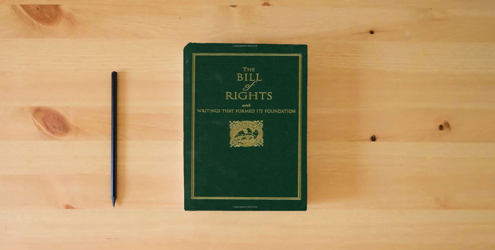 The book Bill of Rights: with Writings that Formed Its Foundation (Books of American Wisdom) is on the table