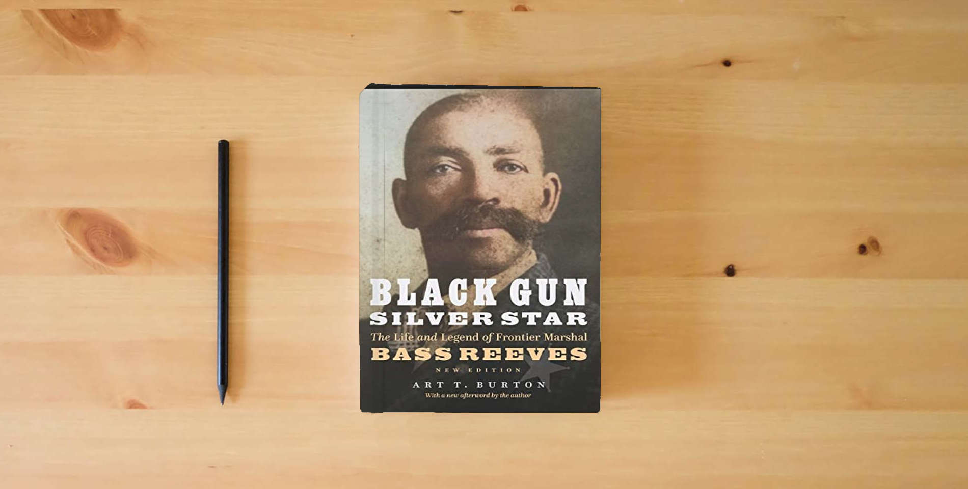 The book Black Gun, Silver Star: The Life and Legend of Frontier Marshal Bass Reeves (Race and Ethnicity in the American West) is on the table