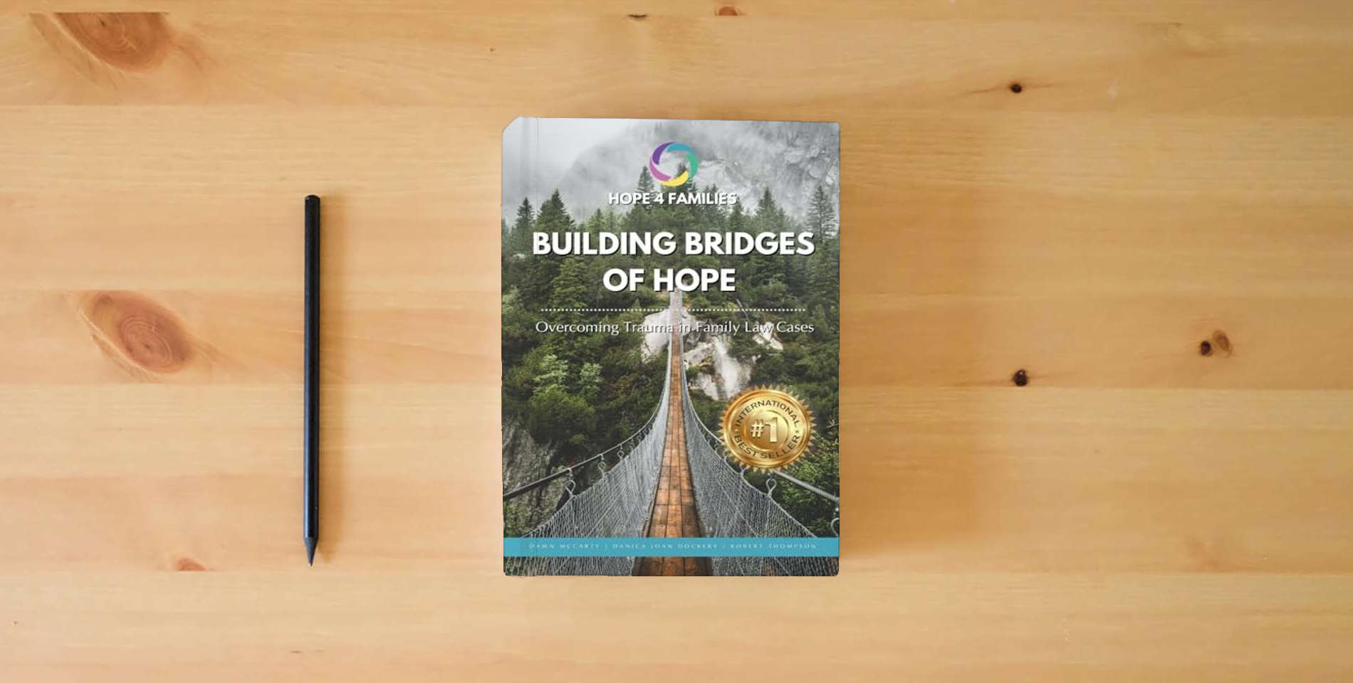 The book Building Bridges of Hope: Overcoming Trauma in the Family Court System is on the table