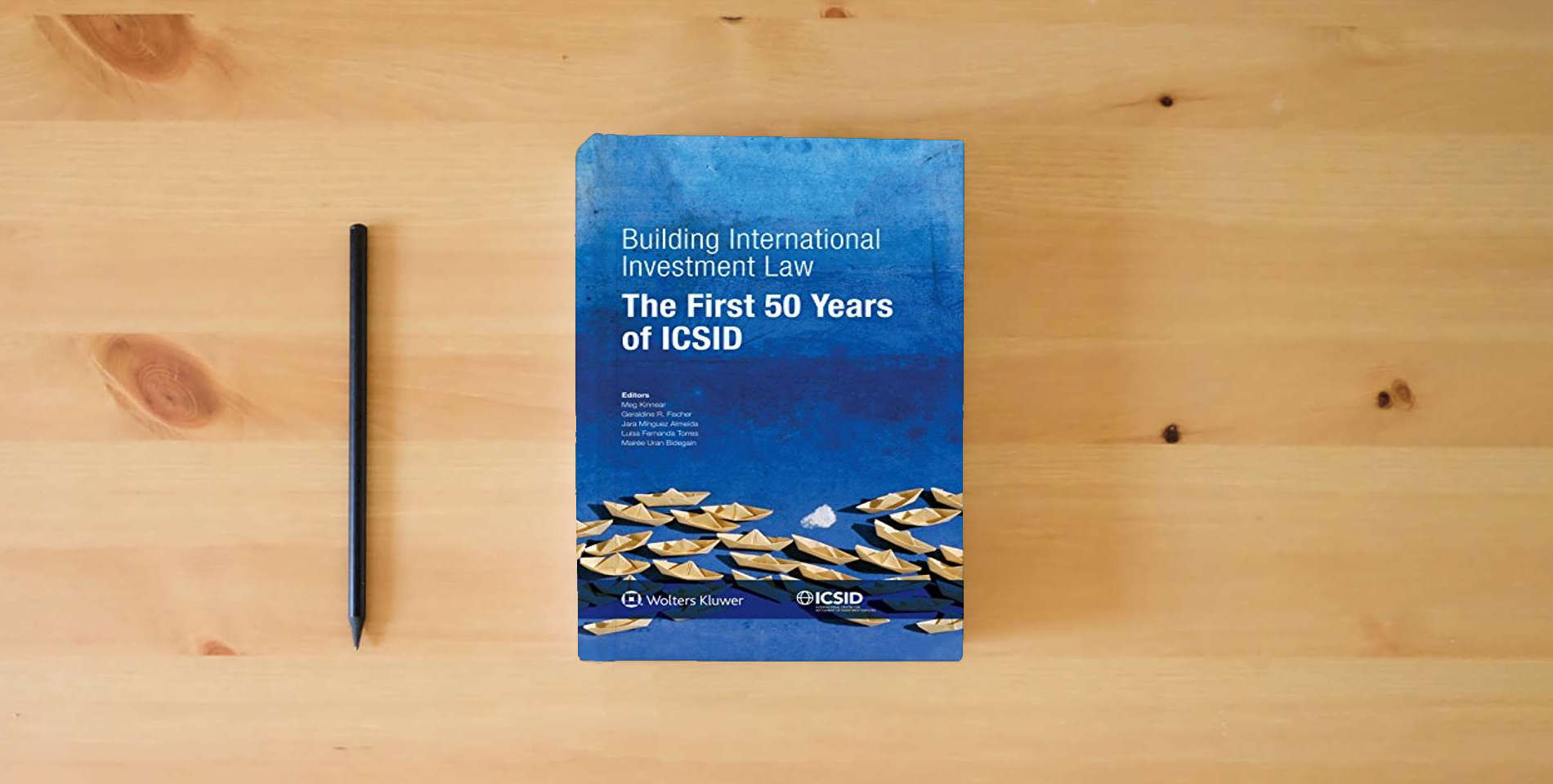 The book Building International Investment Law. The First 50 Years of ICSID is on the table