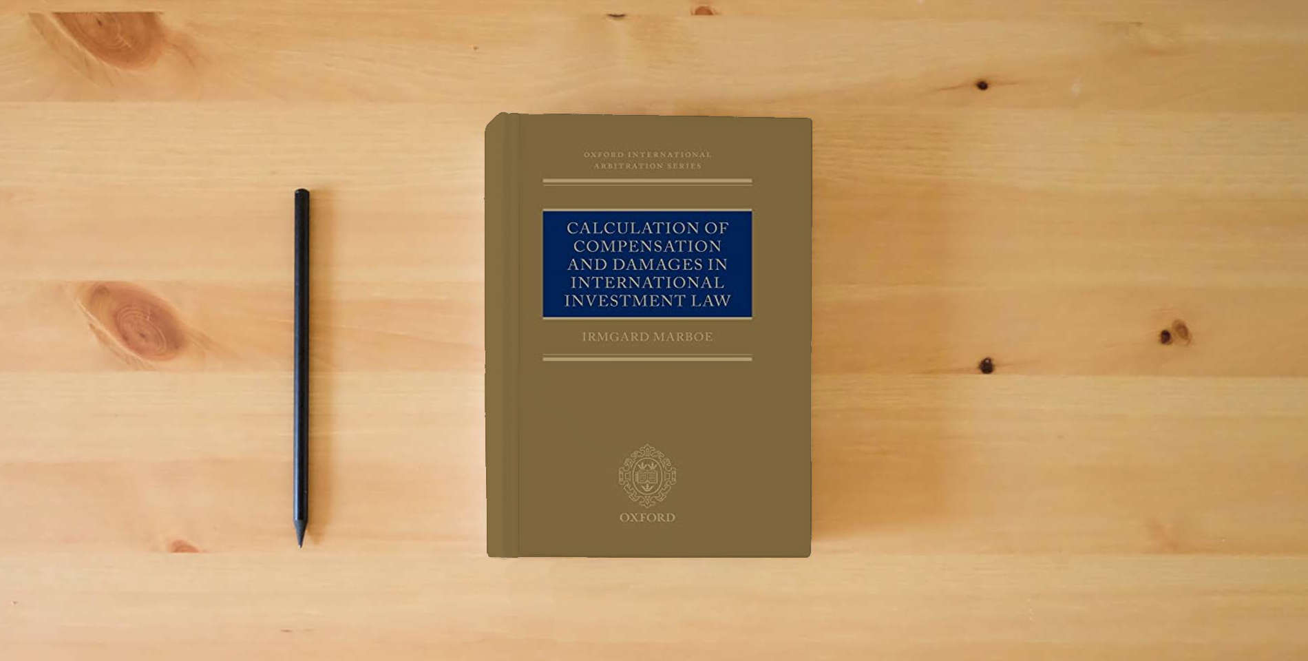 The book Calculation of Compensation and Damages in International Investment Law (Oxford International Arbitration Series) is on the table