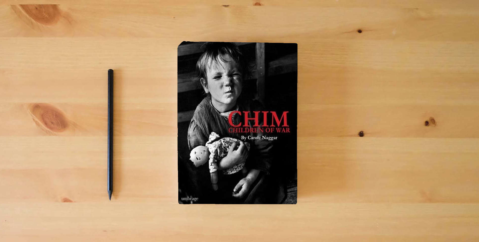The book Chim: Children of War is on the table