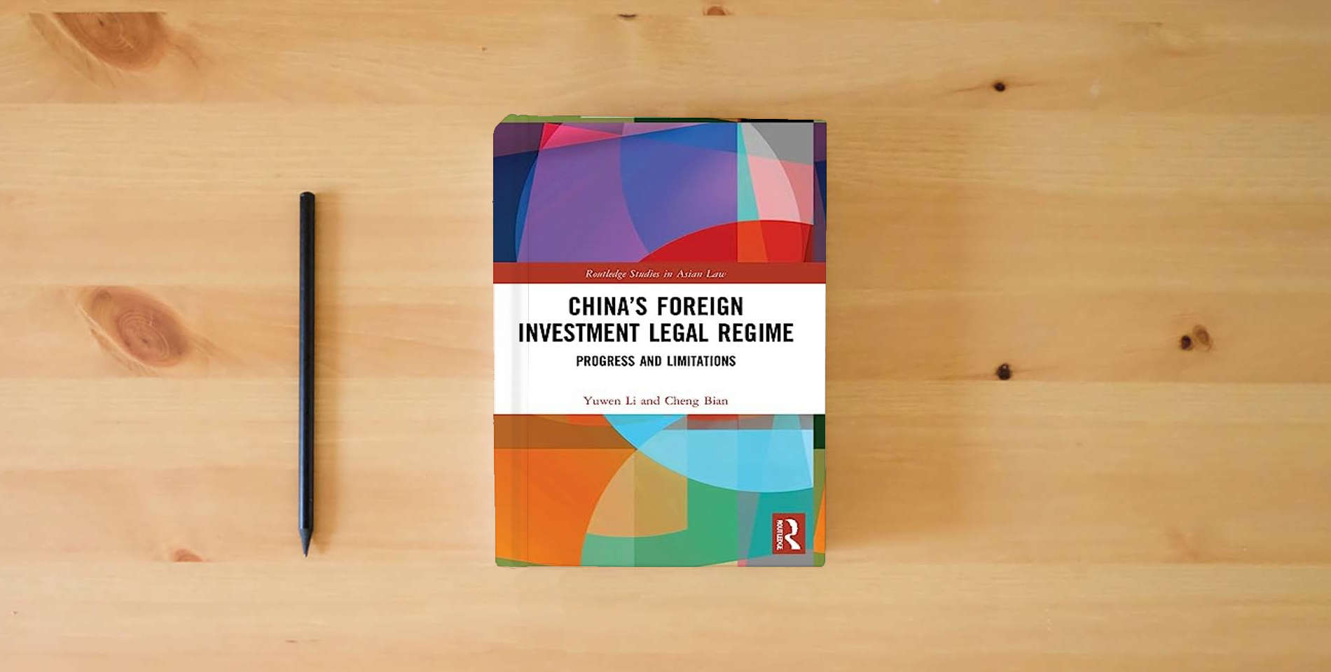 The book China’s Foreign Investment Legal Regime (Routledge Studies in Asian Law) is on the table