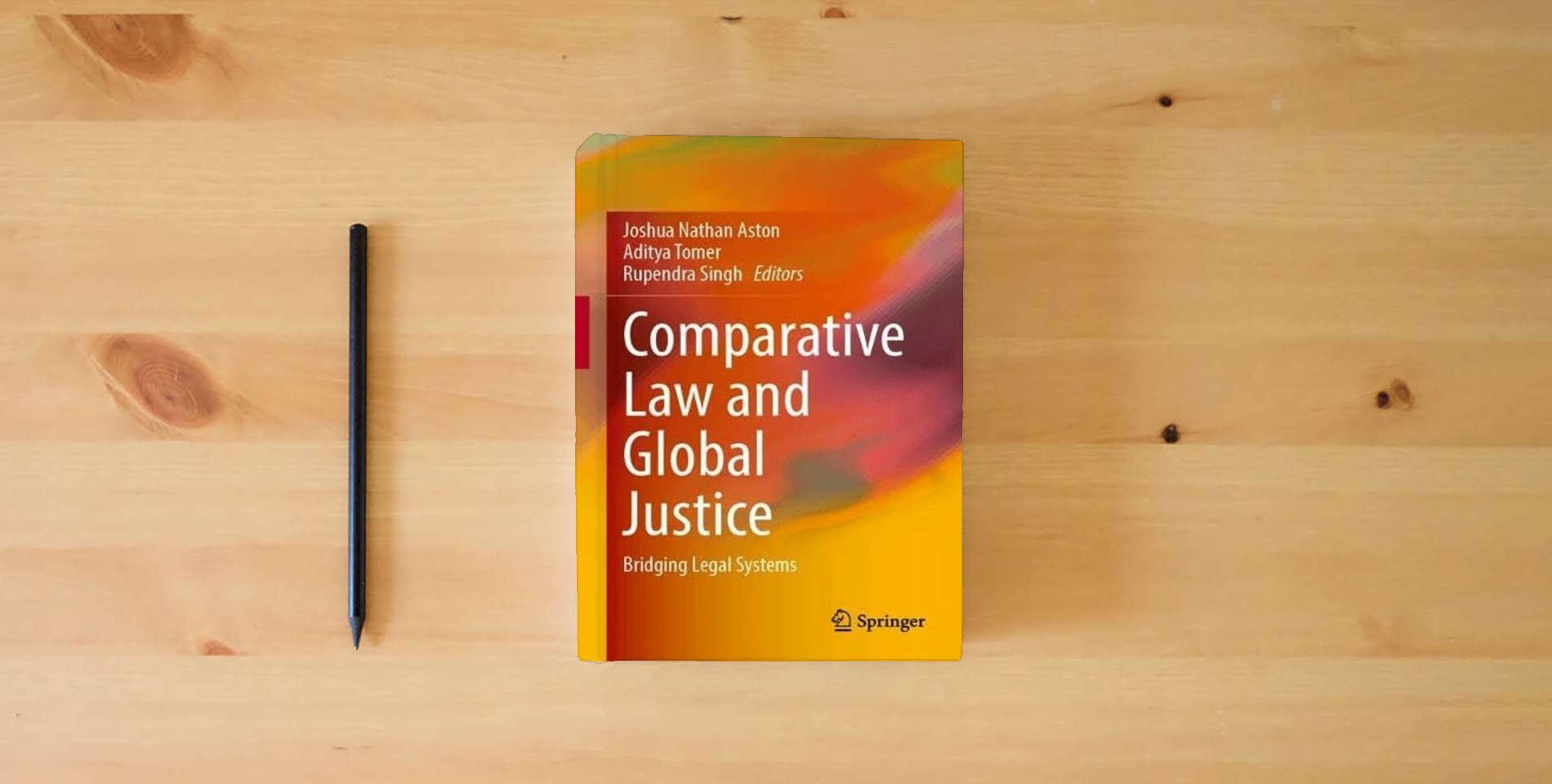 The book Comparative Law and Global Justice: Bridging Legal Systems is on the table
