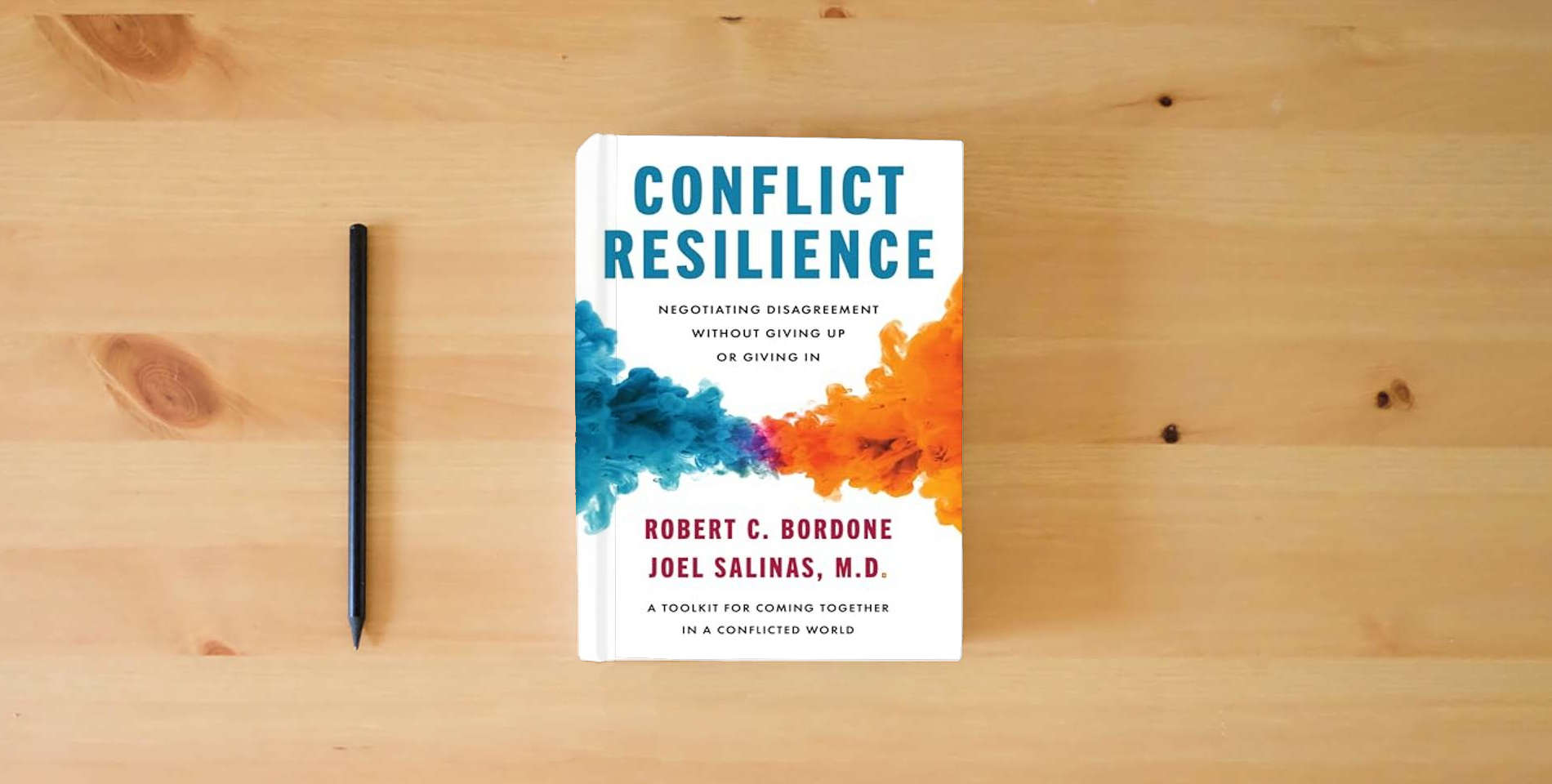 The book Conflict Resilience: Negotiating Disagreement Without Giving Up or Giving In – A USA TODAY Bestselling Harvard Guide to Professional Communication and Workplace Empathy is on the table