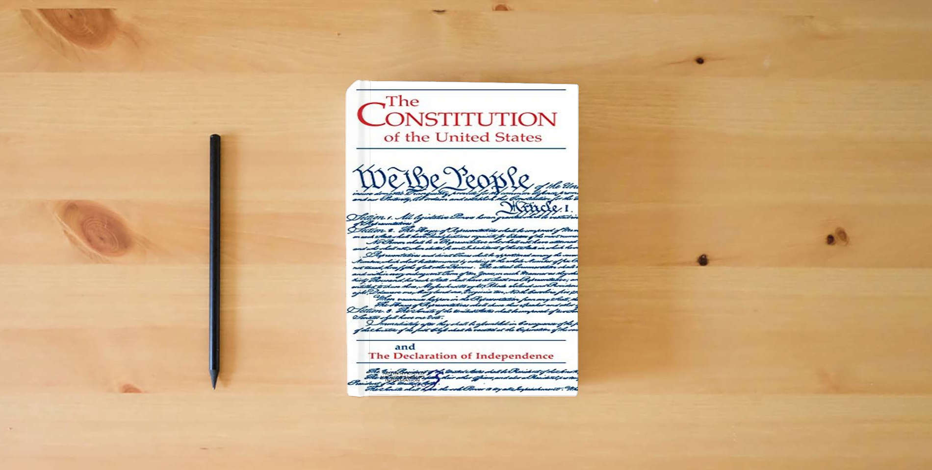 The book Constitution of the United States and the Declaration of Independence (Pocket Edition) is on the table
