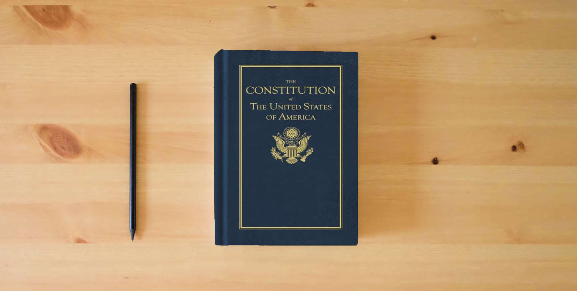 The book Constitution of the United States (Books of American Wisdom) is on the table