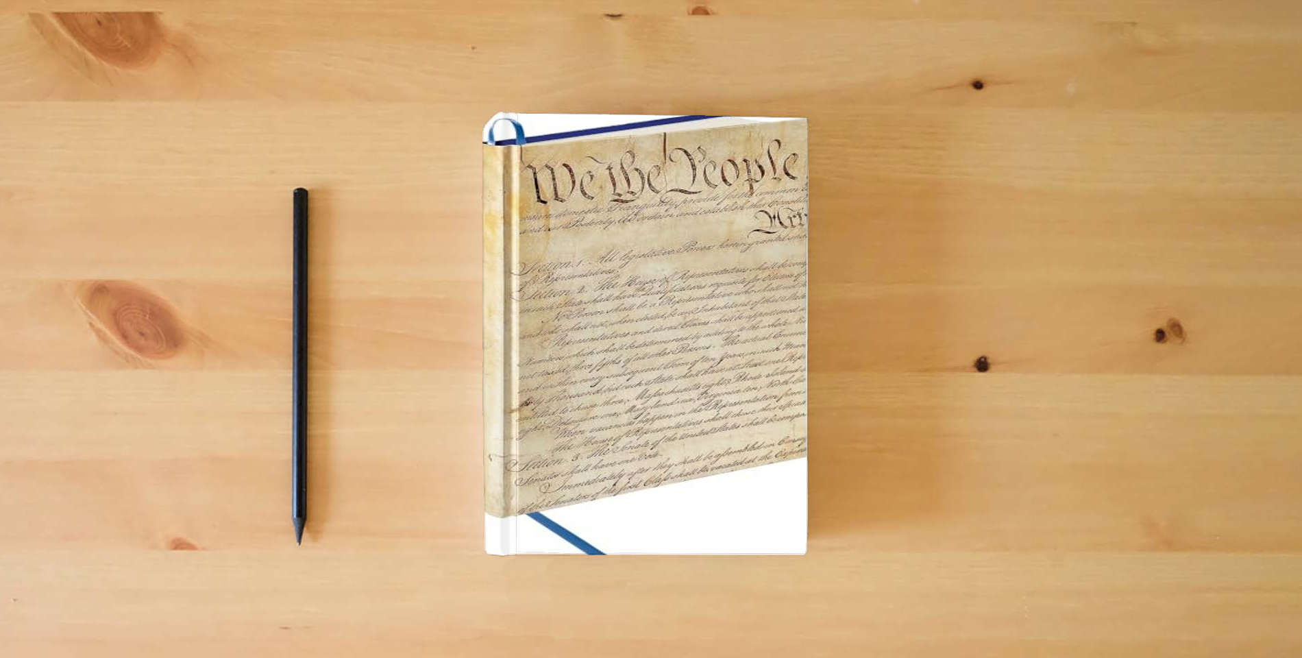 The book Constitution of the United States Writing Journal is on the table