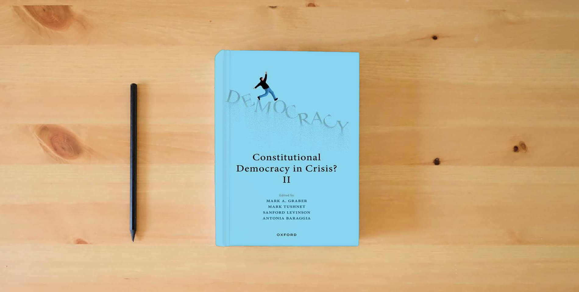 The book Constitutional Democracy in Crisis? II is on the table