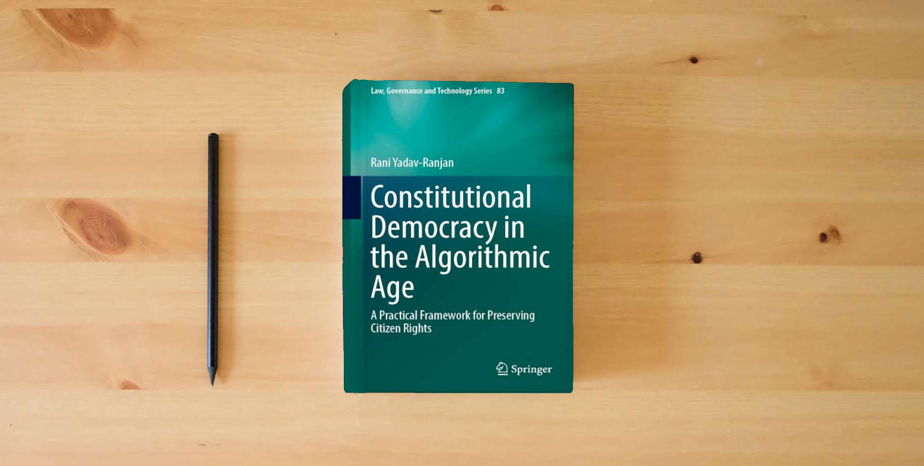 The book Constitutional Democracy in the Algorithmic Age: A Practical Framework for Preserving Citizen Rights (Law, Governance and Technology Series, 83) is on the table