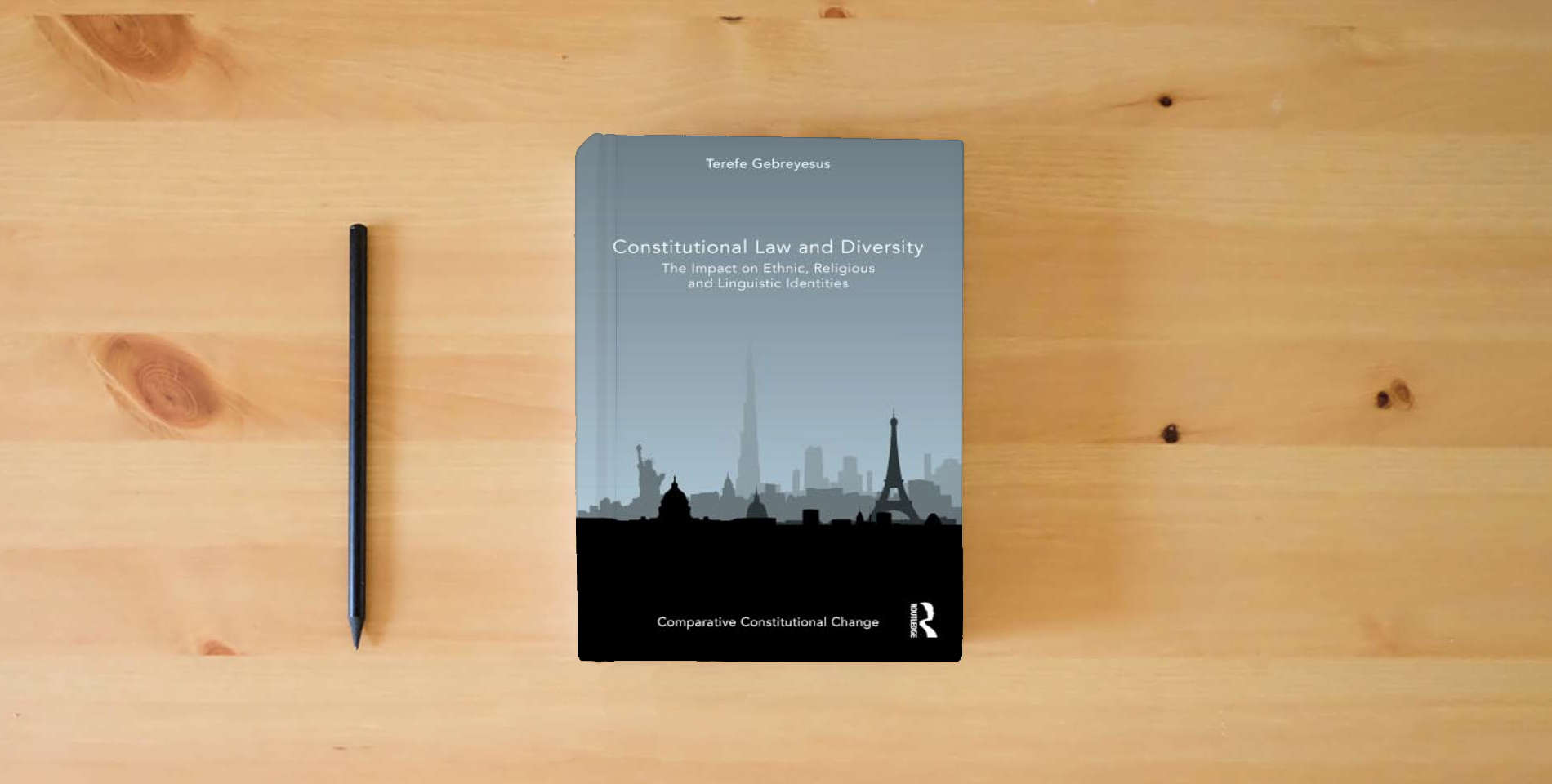 The book Constitutional Law and Diversity: The Impact on Ethnic, Religious and Linguistic Identities (Comparative Constitutional Change) is on the table