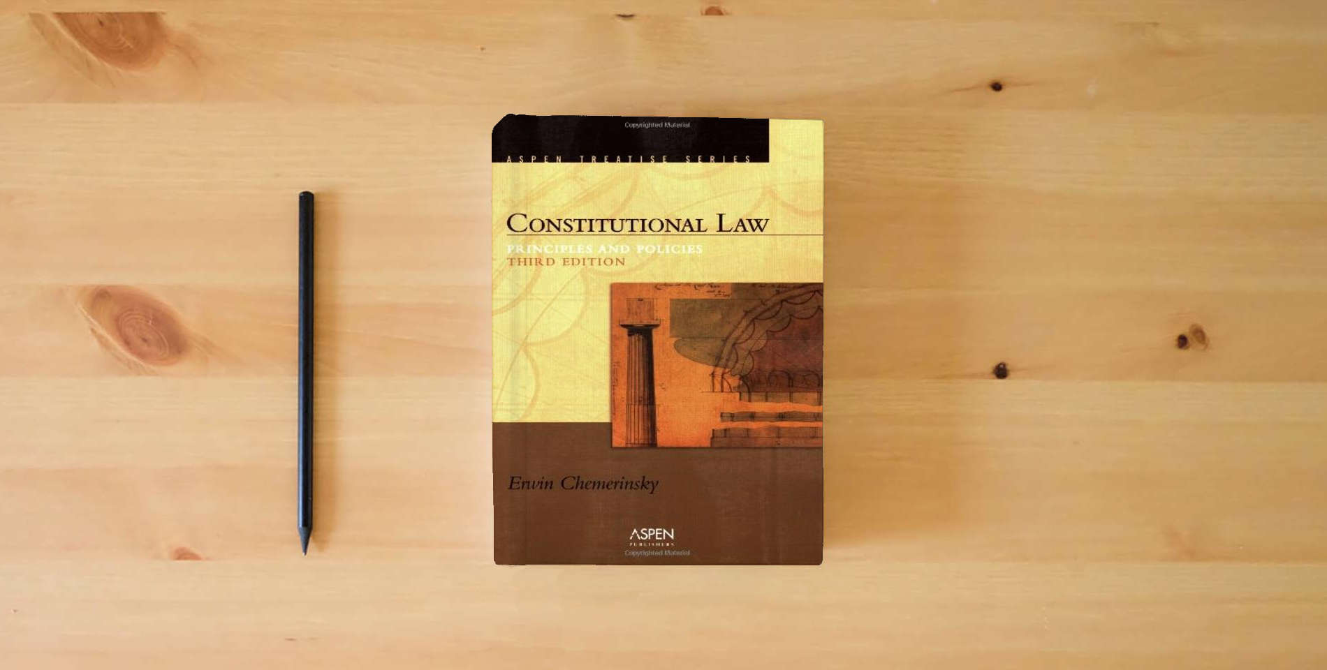 The book Constitutional Law: Principles And Policies (Introduction to Law Series) is on the table