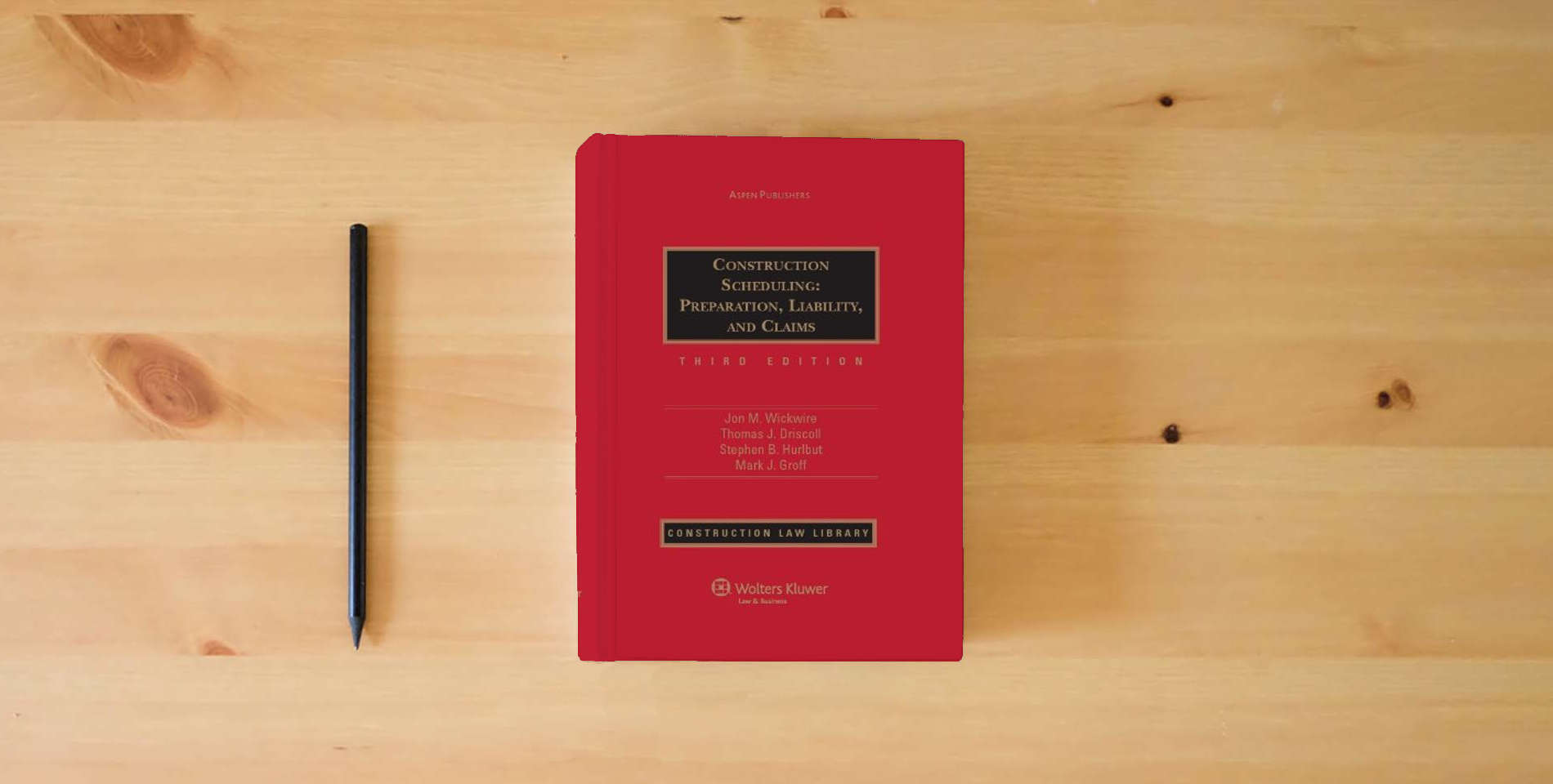 The book Construction Scheduling: Preparation Liability & Claims 3e is on the table