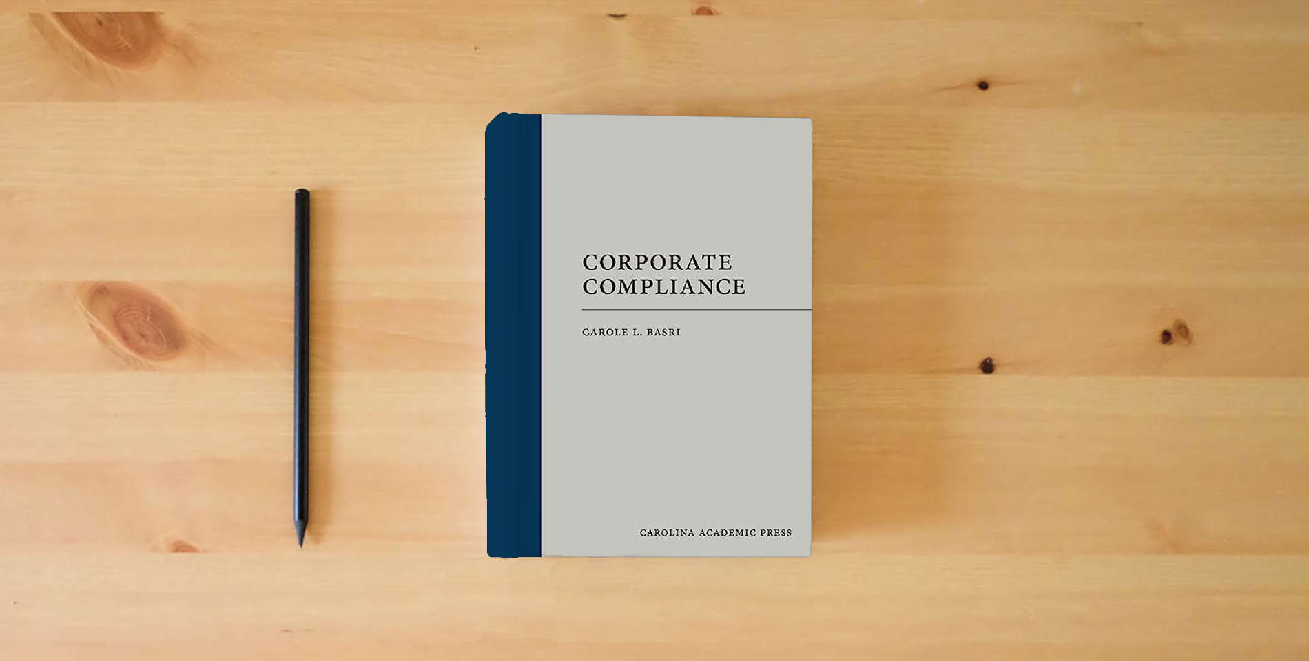 The book Corporate Compliance (Paperback) is on the table