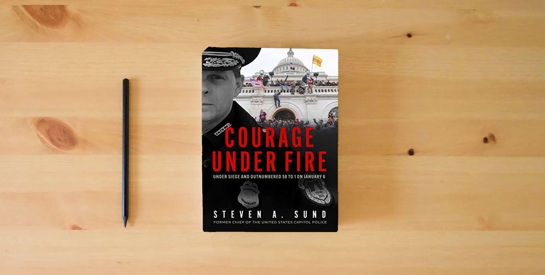 The book Courage Under Fire: The Definitive Account from Inside the Capitol on January 6th is on the table