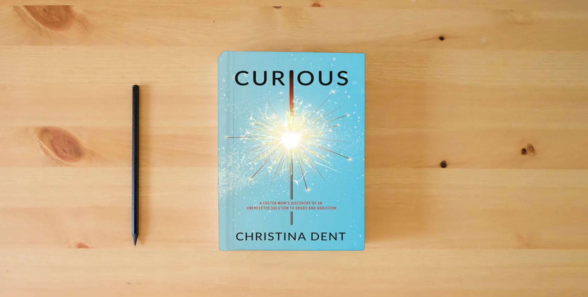 The book Curious: A Foster Mom's Discovery of an Unexpected Solution to Drugs and Addiction is on the table