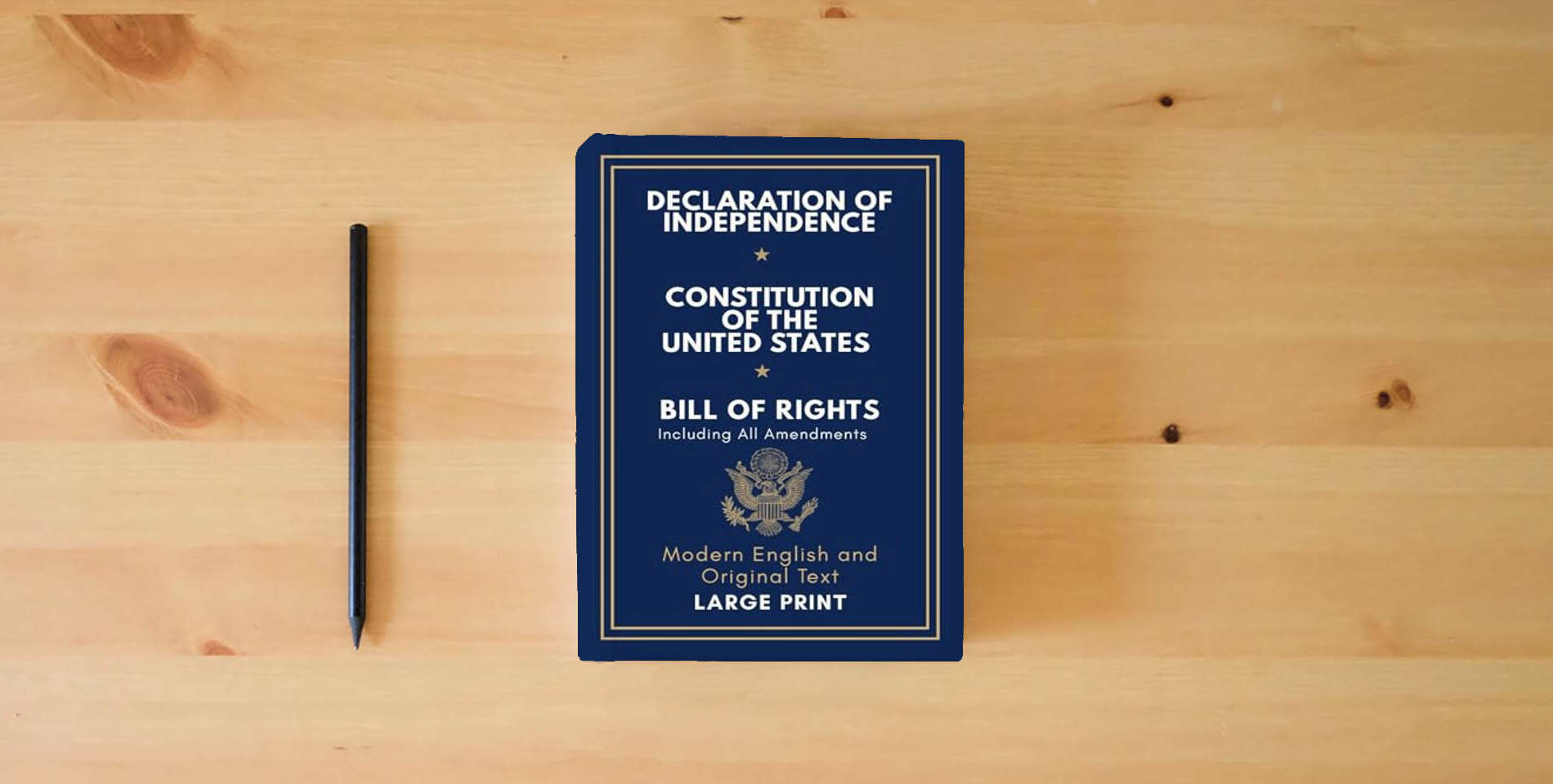 The book Declaration of Independence, Constitution of the United States, Bill of Rights and All Amendments: Original Text and Modern English Paraphrase is on the table