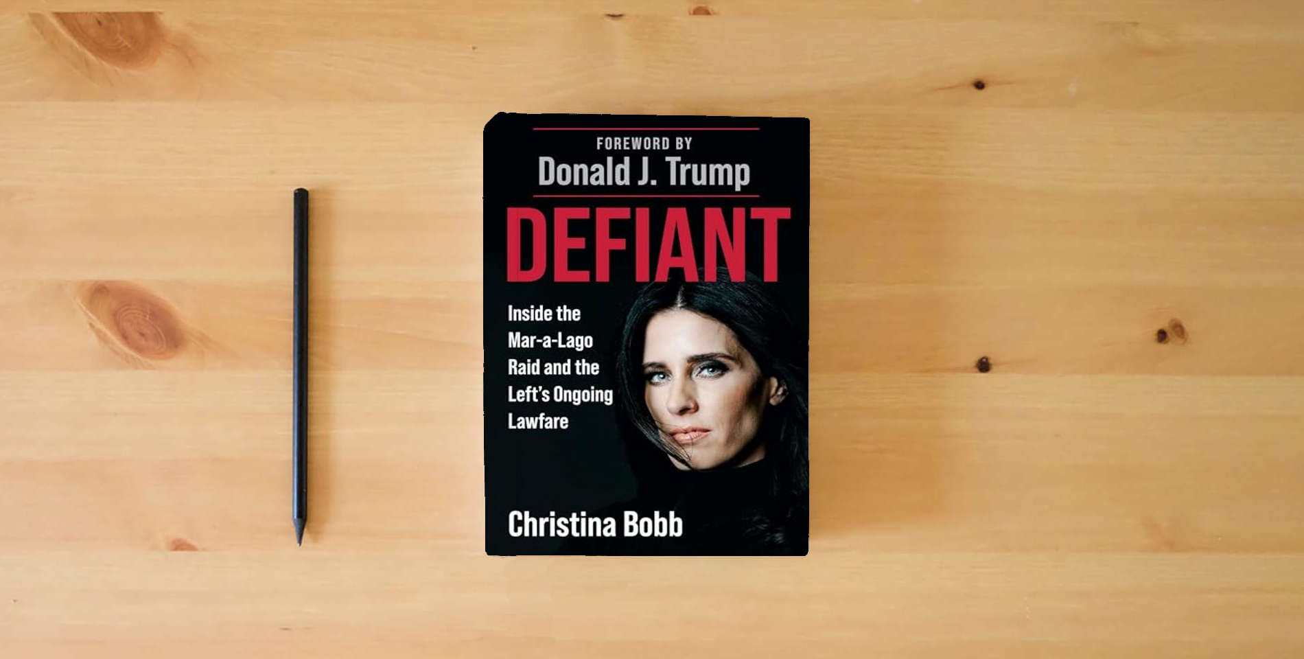 The book Defiant: Inside the Mar-a-Lago Raid and the Left's Ongoing Lawfare is on the table
