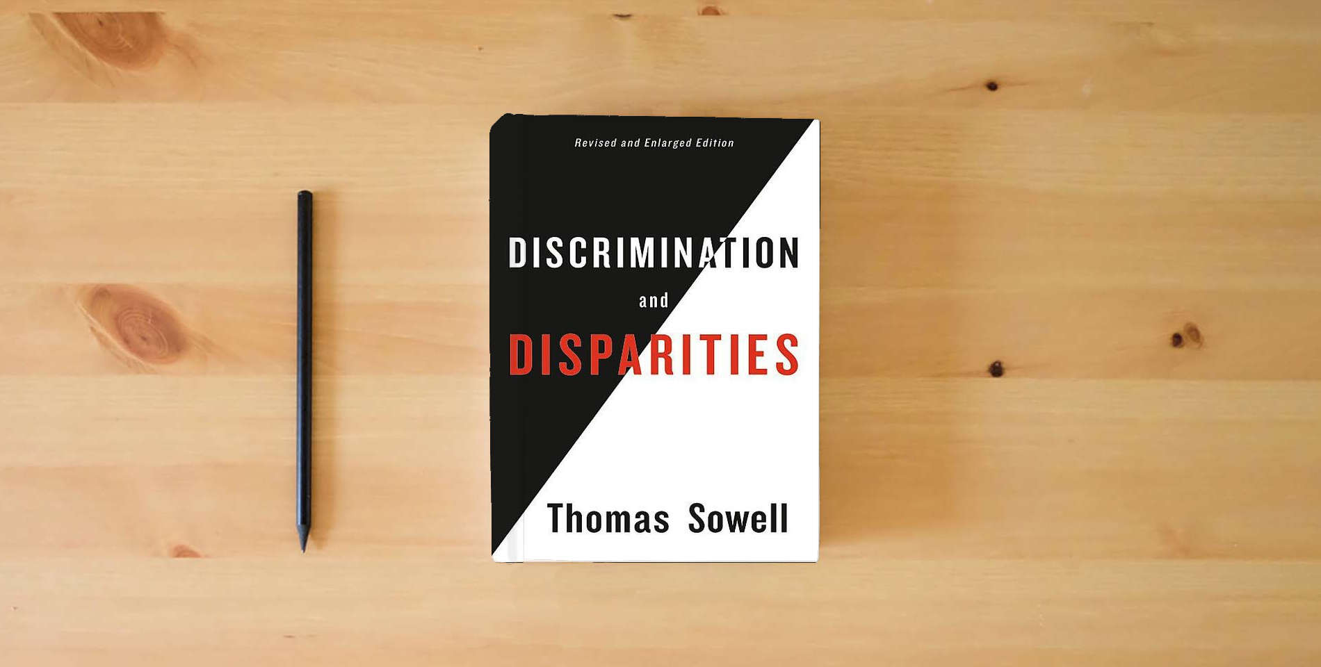 The book Discrimination and Disparities is on the table