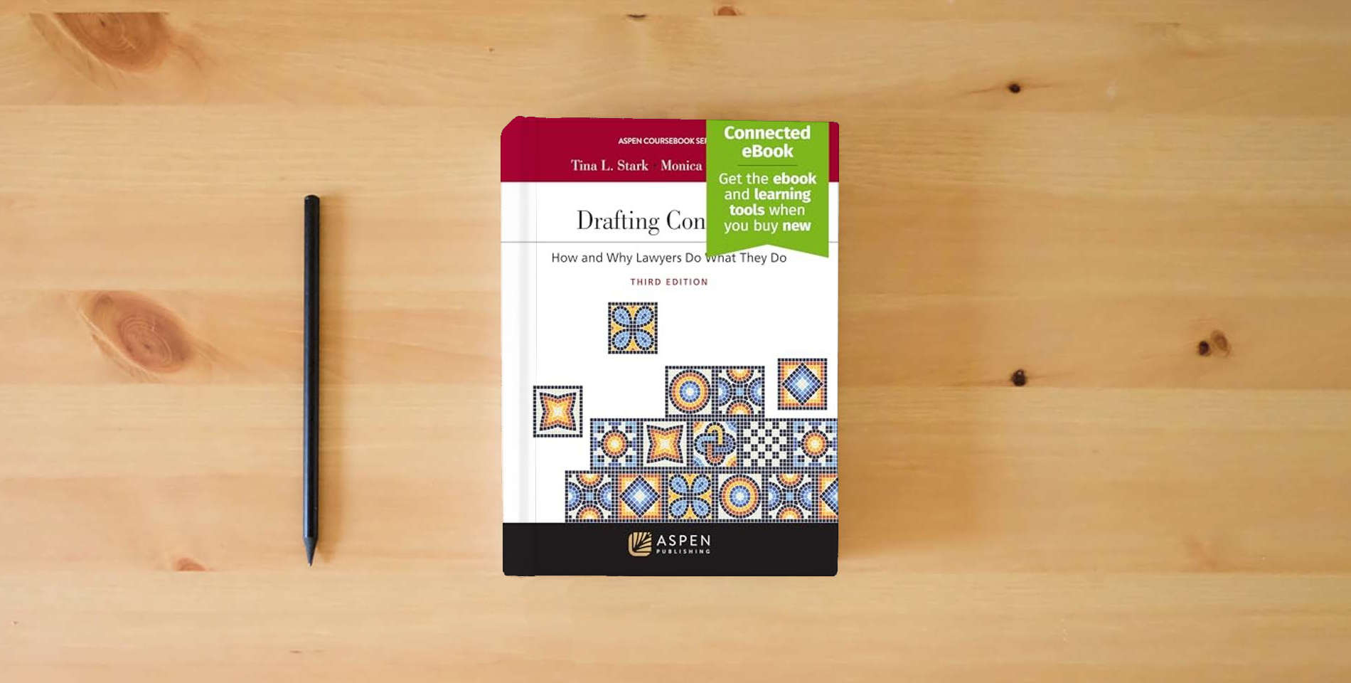 The book Drafting Contracts: How and Why Lawyers Do What They Do [Connected Ebook] (Aspen Coursebook) (Aspen Coursebook Series) is on the table