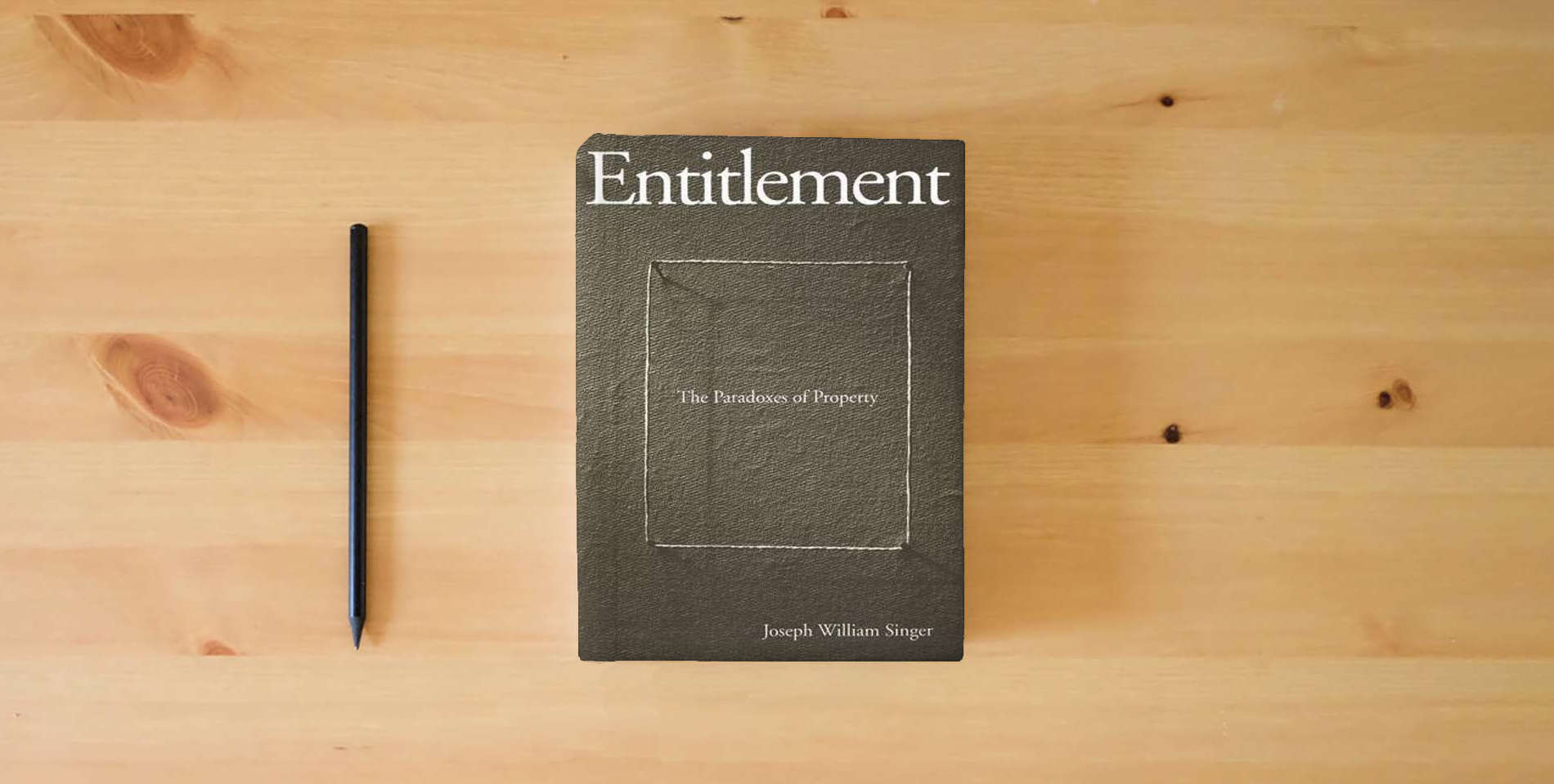 The book Entitlement: The Paradoxes of Property is on the table