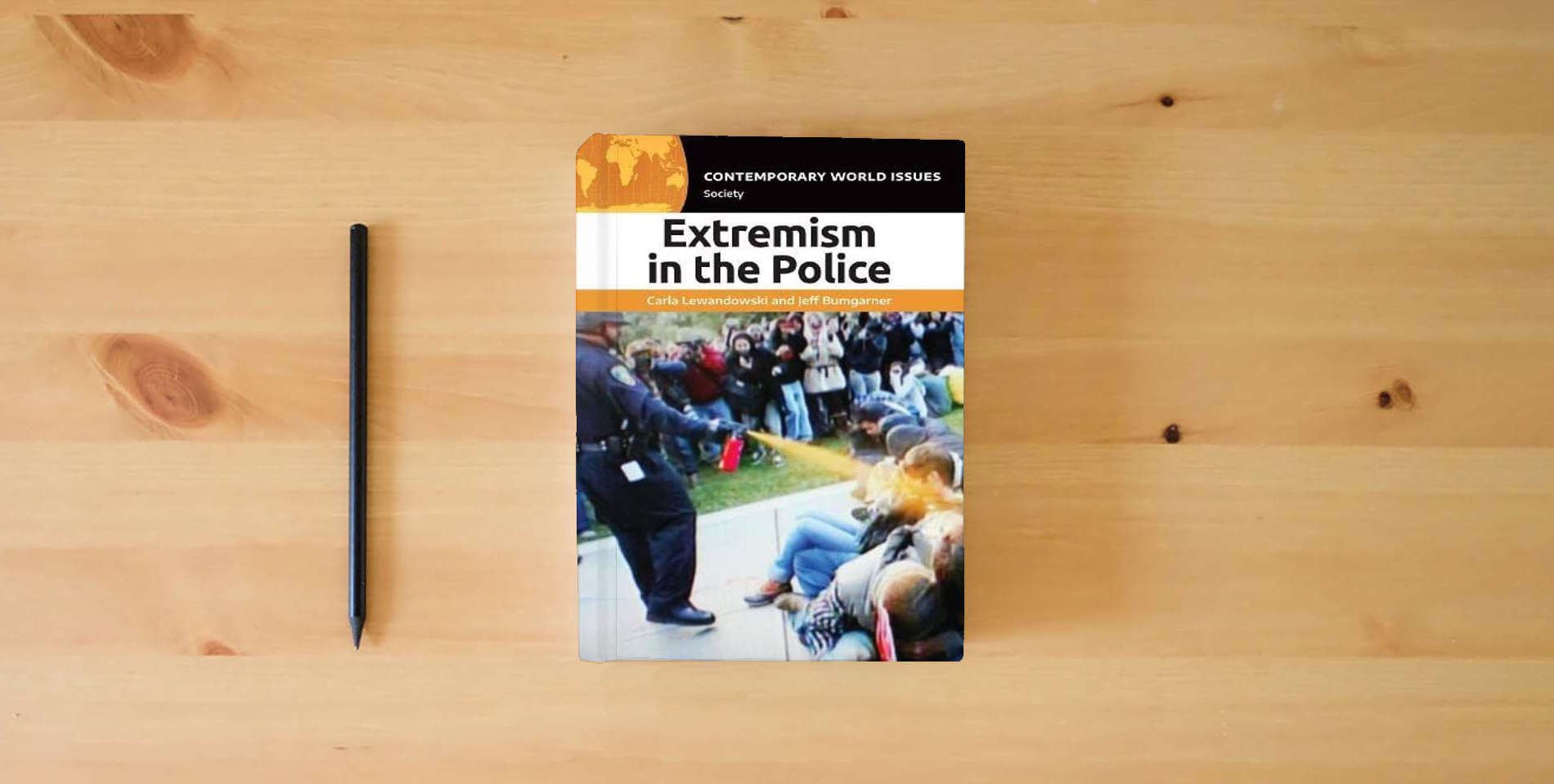 The book Extremism in the Police: A Reference Handbook (Contemporary World Issues) is on the table