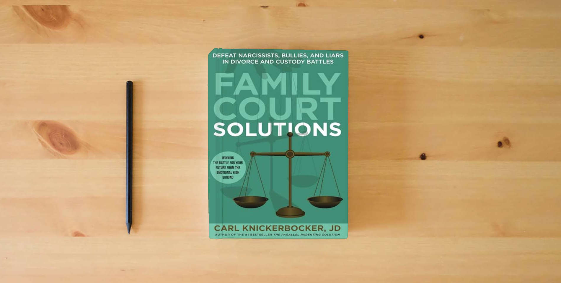 The book Family Court Solutions: Defeat Narcissists, Bullies, and Liars in Divorce and Custody Cases is on the table
