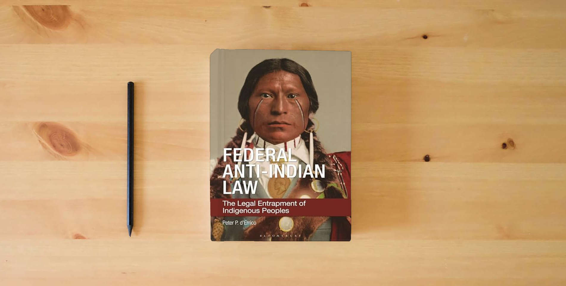 The book Federal Anti-Indian Law: The Legal Entrapment of Indigenous Peoples is on the table