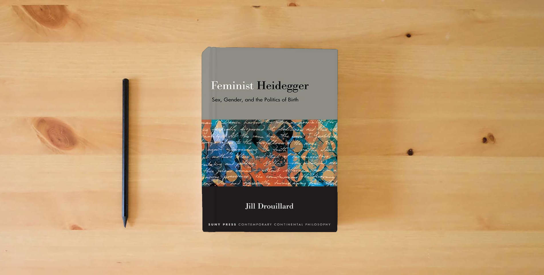 The book Feminist Heidegger: Sex, Gender, and the Politics of Birth (Suny Contemporary Continental Philosophy) is on the table