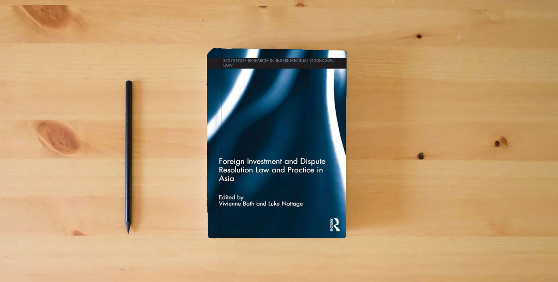 The book Foreign Investment and Dispute Resolution Law and Practice in Asia (Routledge Research in International Economic Law) is on the table