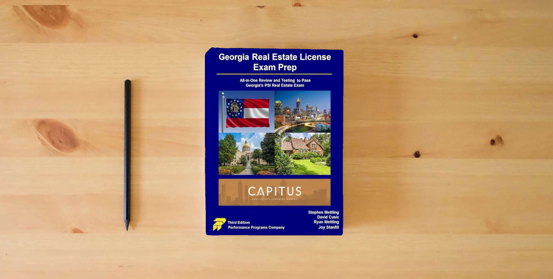 The book Georgia Real Estate License Exam Prep: Capitus Real Estate Learning Center Edition is on the table