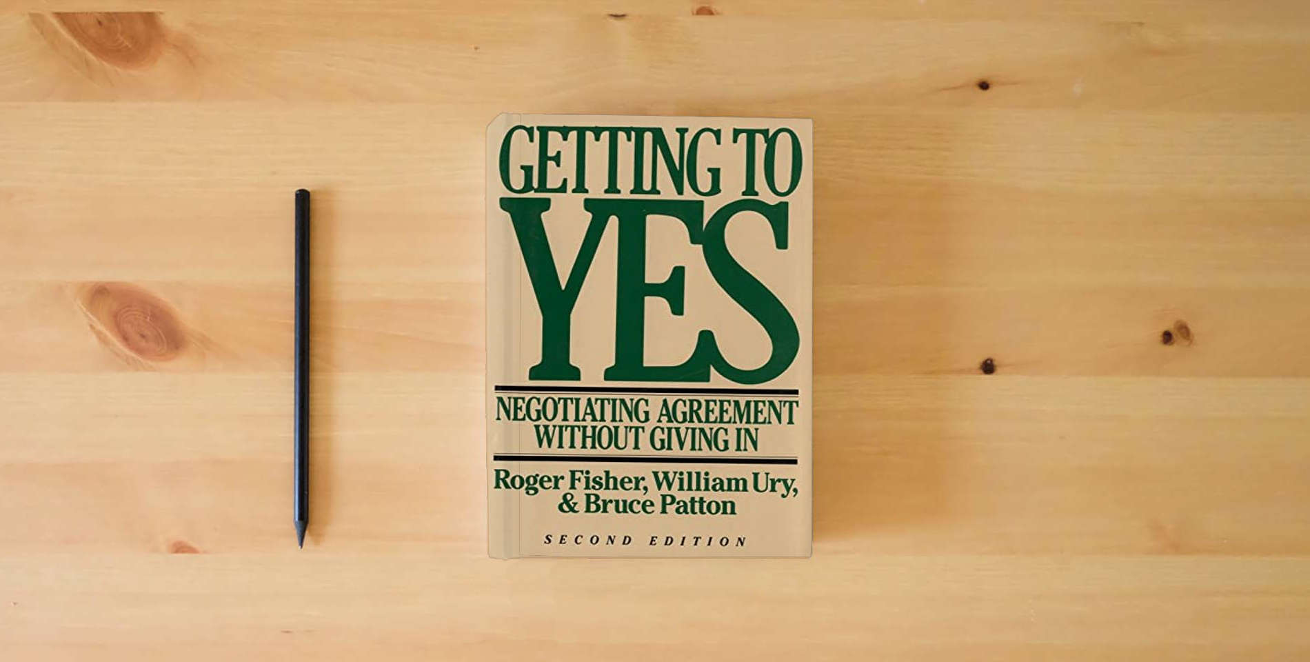 The book Getting to Yes: Negotiating Agreement Without Giving In is on the table