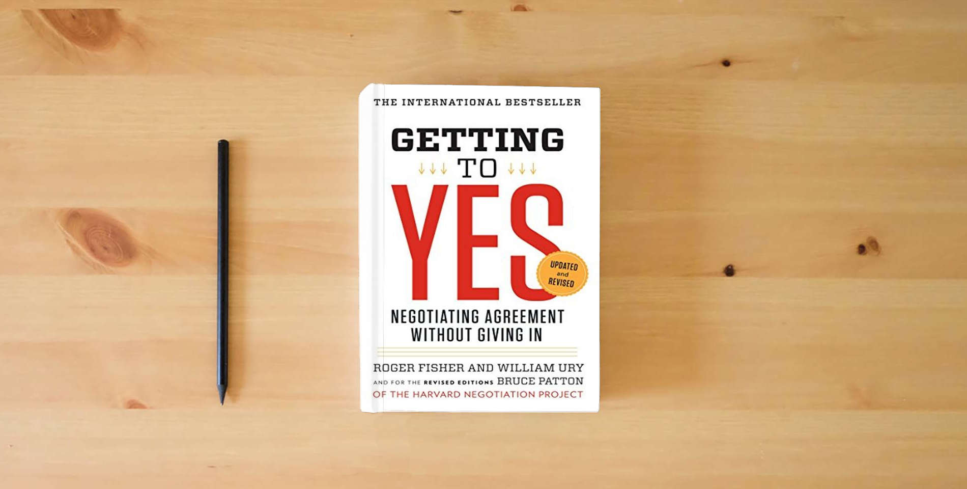 The book Getting to Yes: Negotiating Agreement Without Giving In is on the table