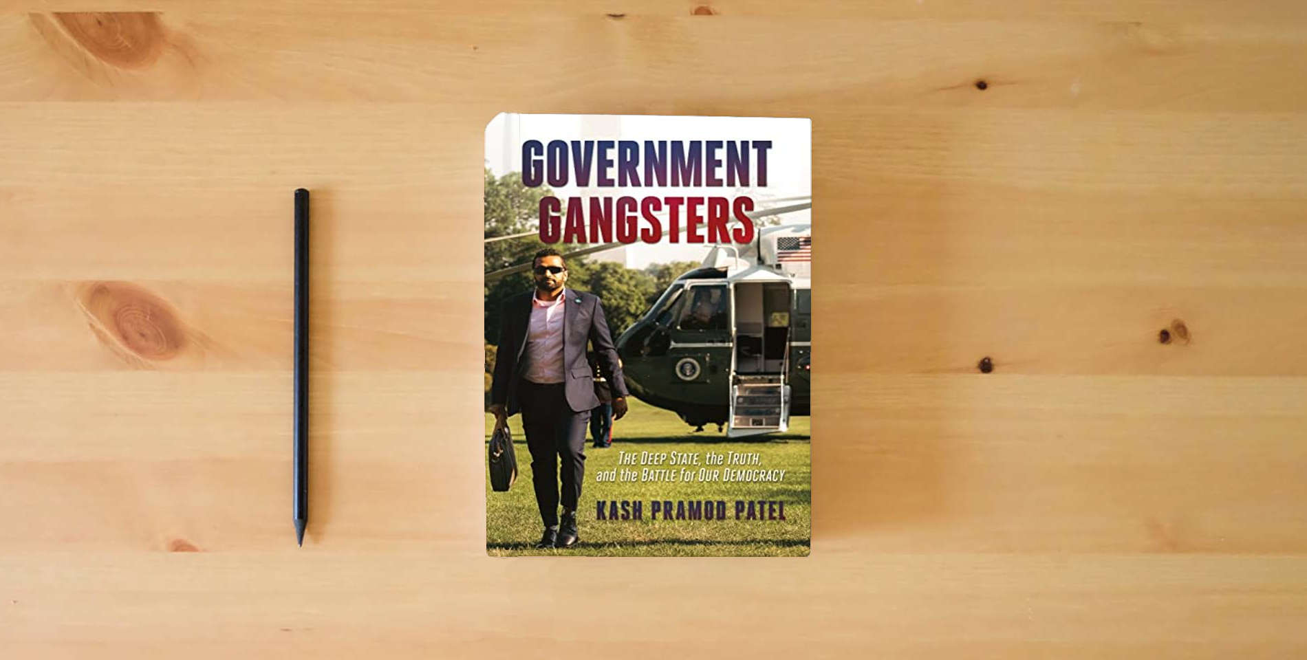 The book Government Gangsters: The Deep State, the Truth, and the Battle for Our Democracy is on the table