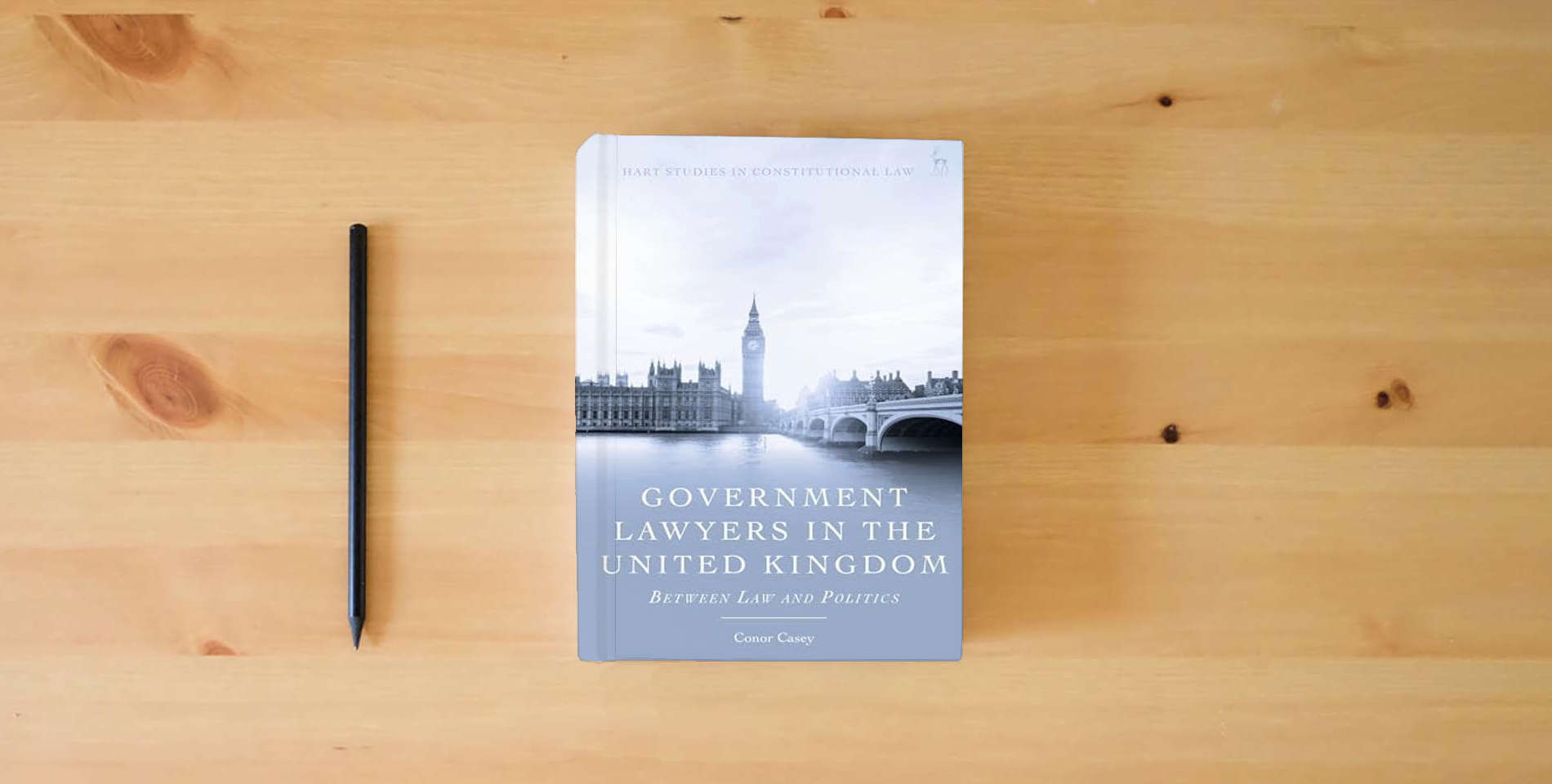 The book Government Lawyers in the United Kingdom: Between Law and Politics (Hart Studies in Constitutional Law) is on the table
