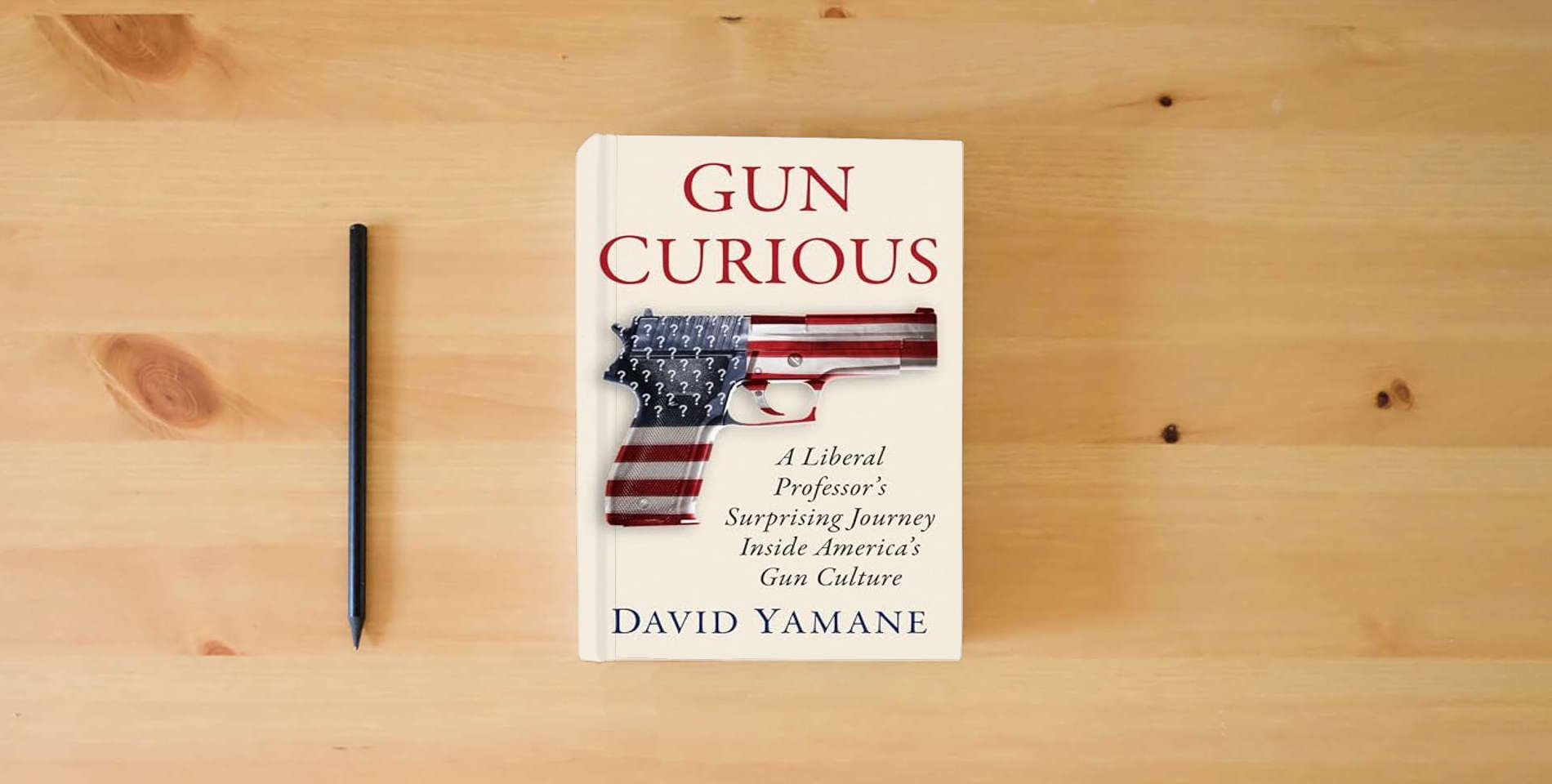 The book Gun Curious: A Liberal Professor's Surprising Journey Inside America's Gun Culture is on the table