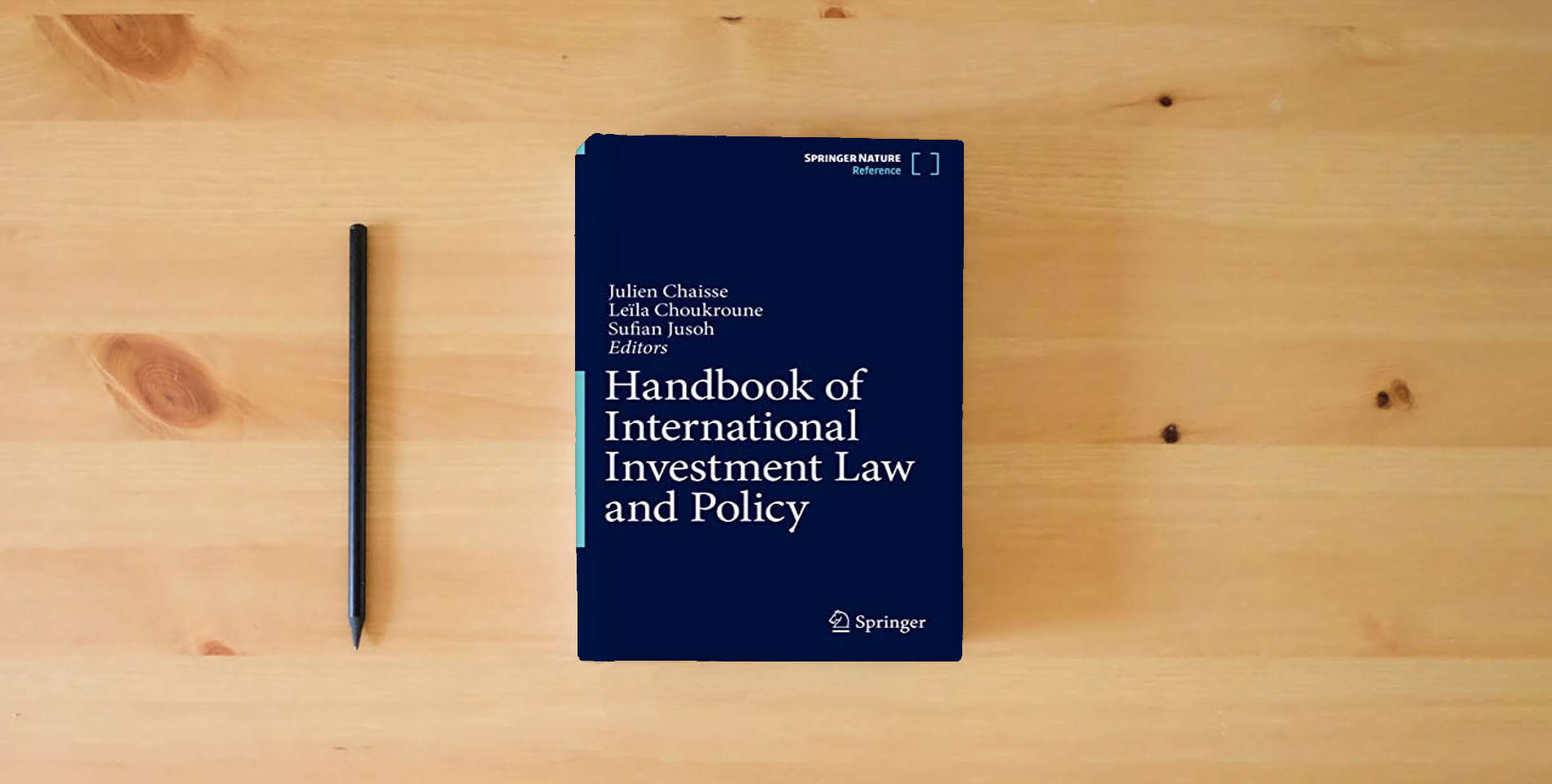 The book Handbook of International Investment Law and Policy is on the table