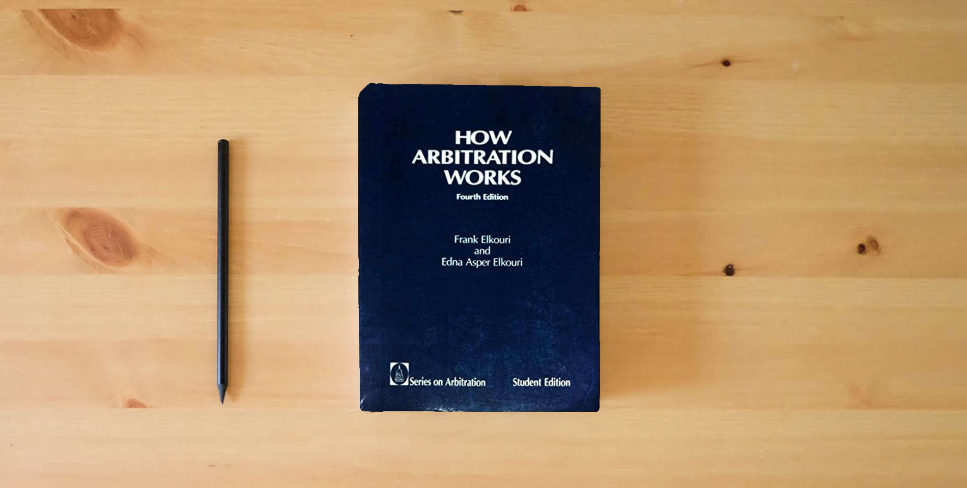 The book How Arbitration Works is on the table