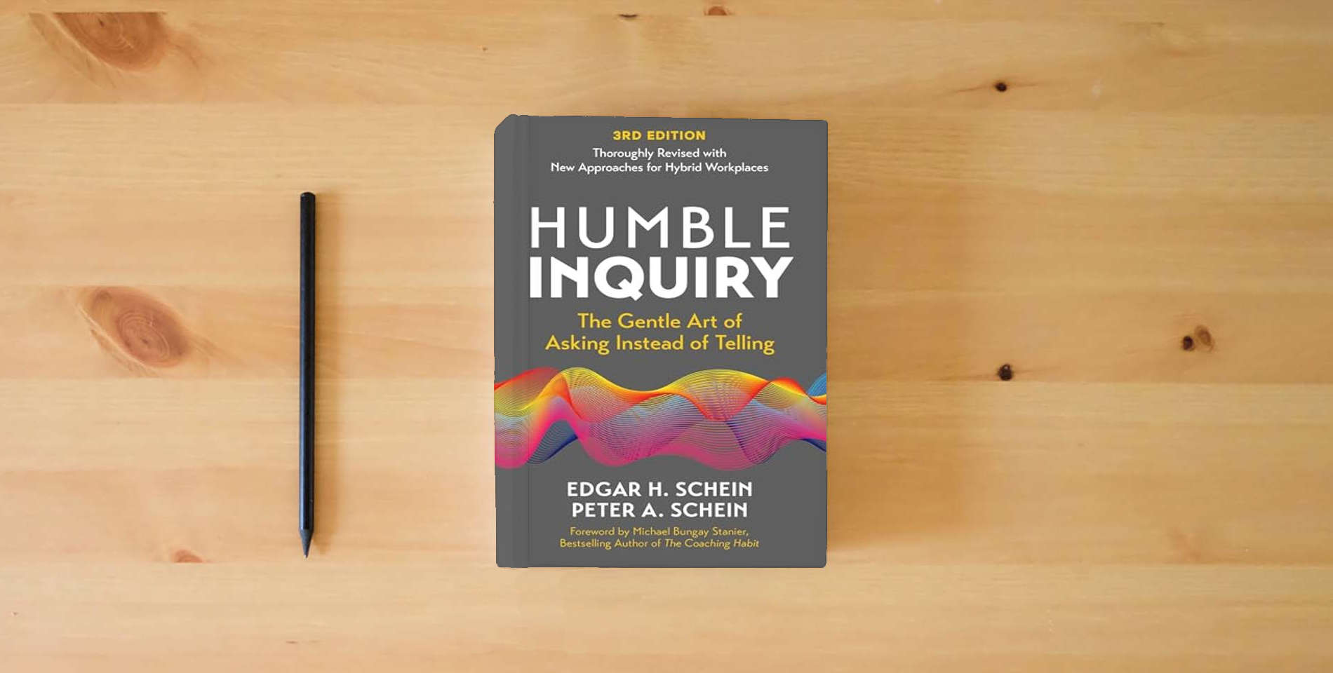 The book Humble Inquiry, 3rd Edition: The Gentle Art of Asking Instead of Telling (The Humble Leadership Series) is on the table