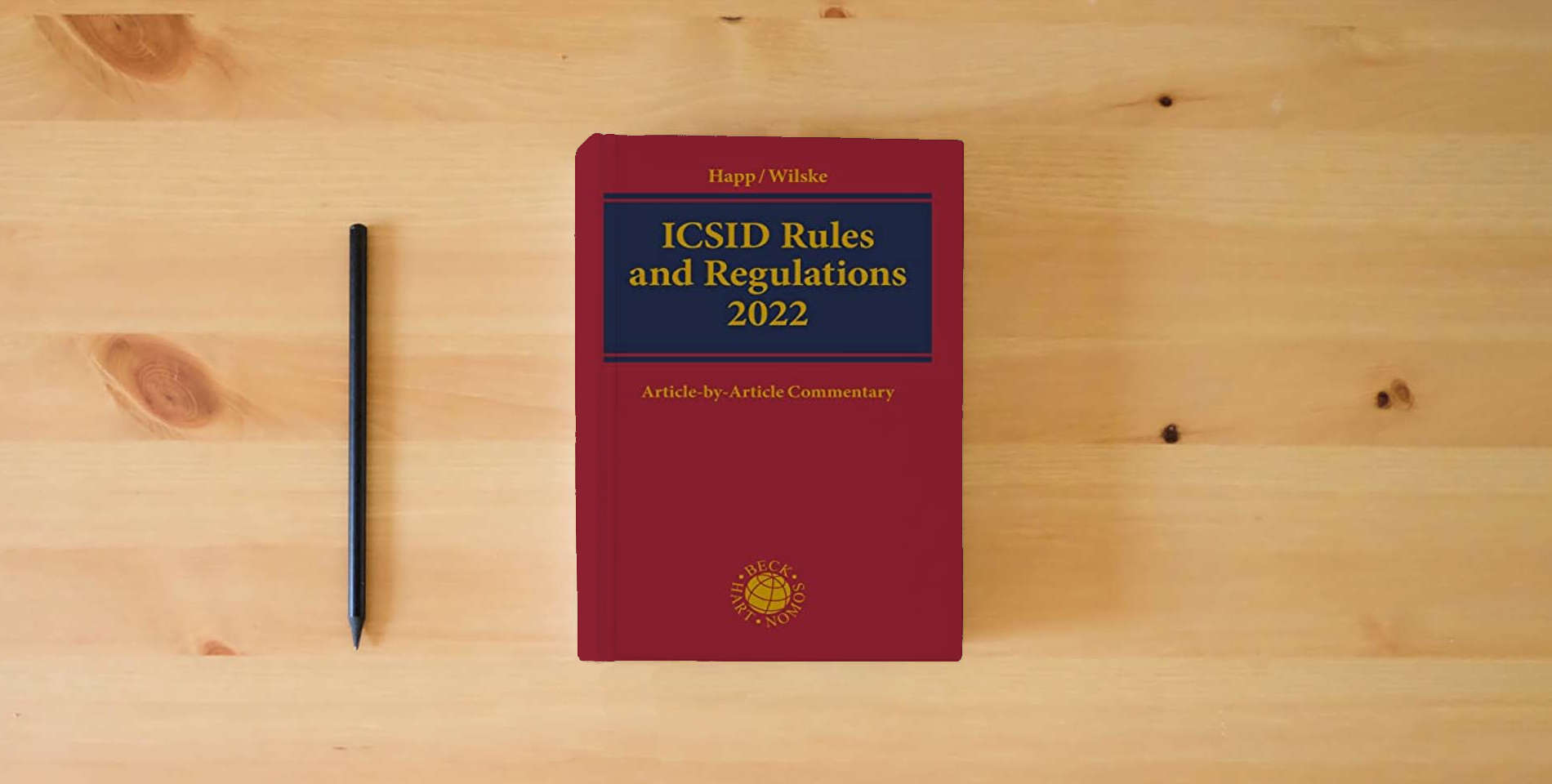 The book ICSID Rules and Regulations 2022: Article-by-Article Commentary is on the table